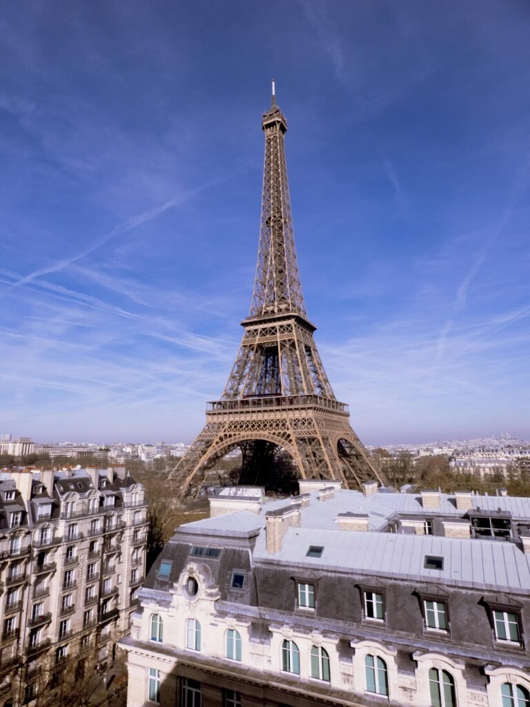 Captivating view of the iconic Eiffel Tower in Paris against a clear blue sky, showcasing architectural beauty.