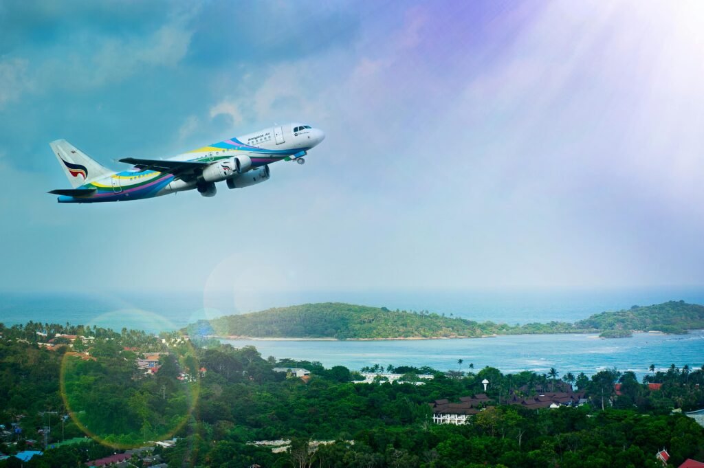 pexels-photo-1004584-1004584 Airplane soaring over Koh Samui island, Thailand, showcasing a vibrant tropical landscape in daylight.