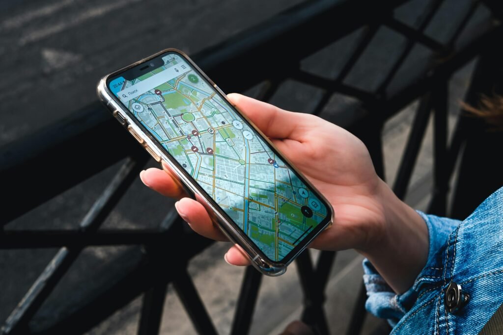 pexels-photo-8824105-8824105 An outdoor close-up of a hand holding a smartphone displaying a map application.