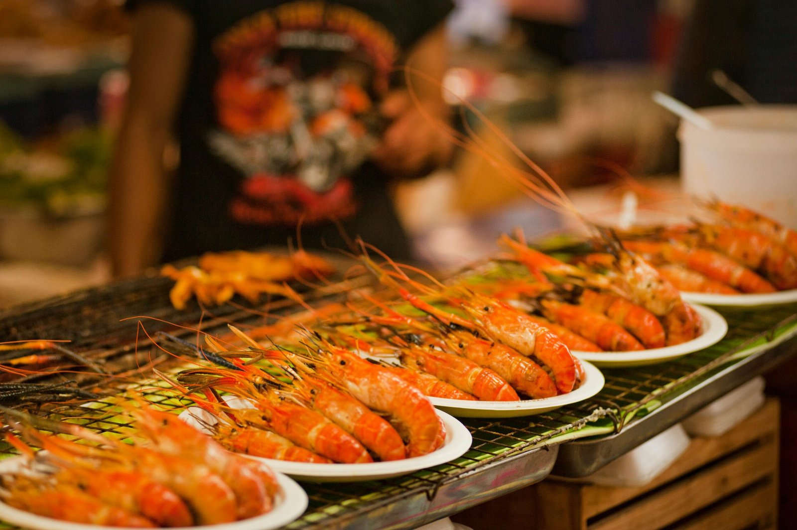 pexels-photo-1031780-1031780 Deliciously grilled shrimps on plates ready to serve at a vibrant Bangkok street food market.