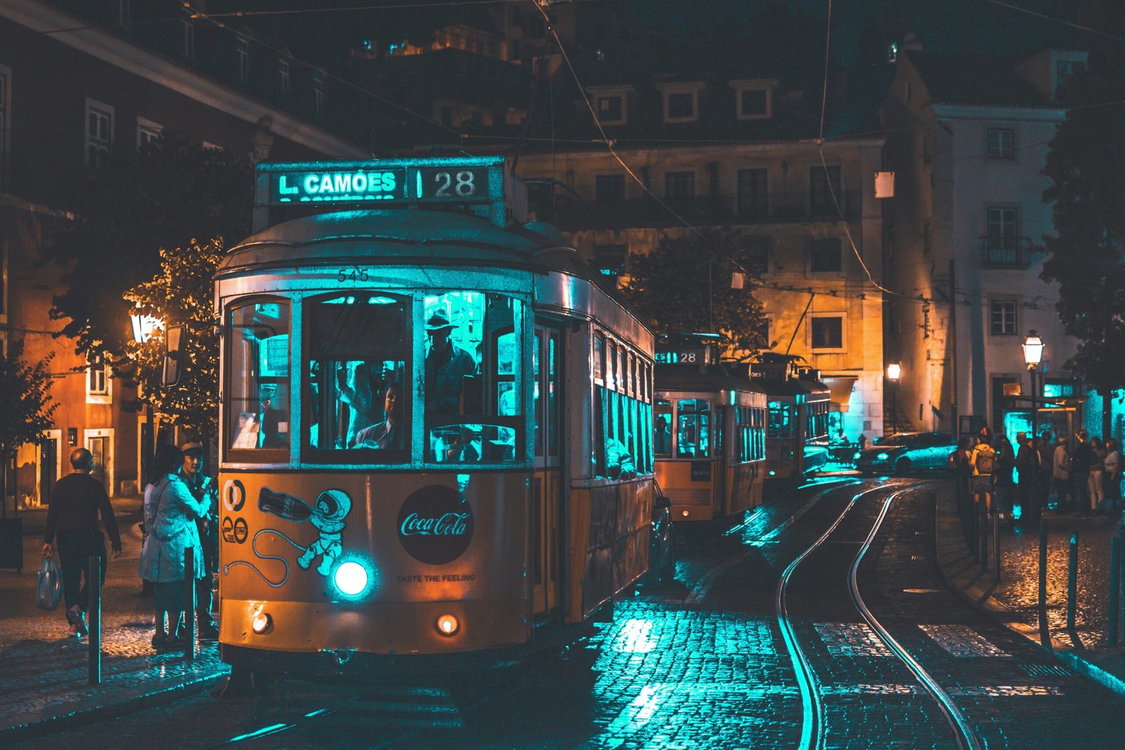 pexels-photo-1545510-1545510 Illuminated vintage tram rides through Lisbon at night showcasing urban life and street lighting ambiance.