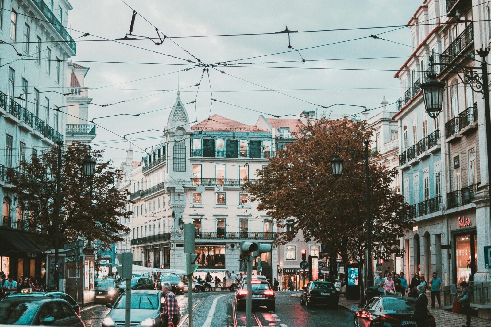 pexels-photo-1599497-1599497 Explore a bustling street scene in Lisbon, Portugal, featuring stunning classic architecture and lively urban traffic.