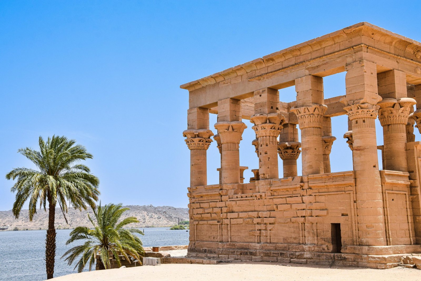 Explore the majestic ruins of an ancient temple by the Nile in Aswan, Egypt.