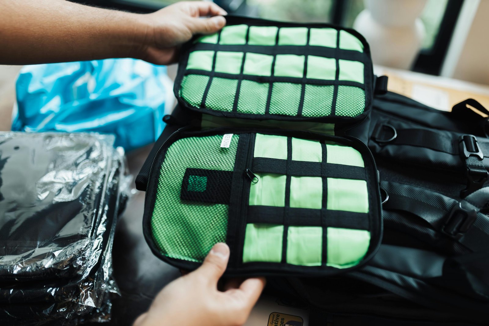 pexels-photo-18999368-18999368-1 Close-up of hands organizing a travel luggage with packing cubes for efficient packing.