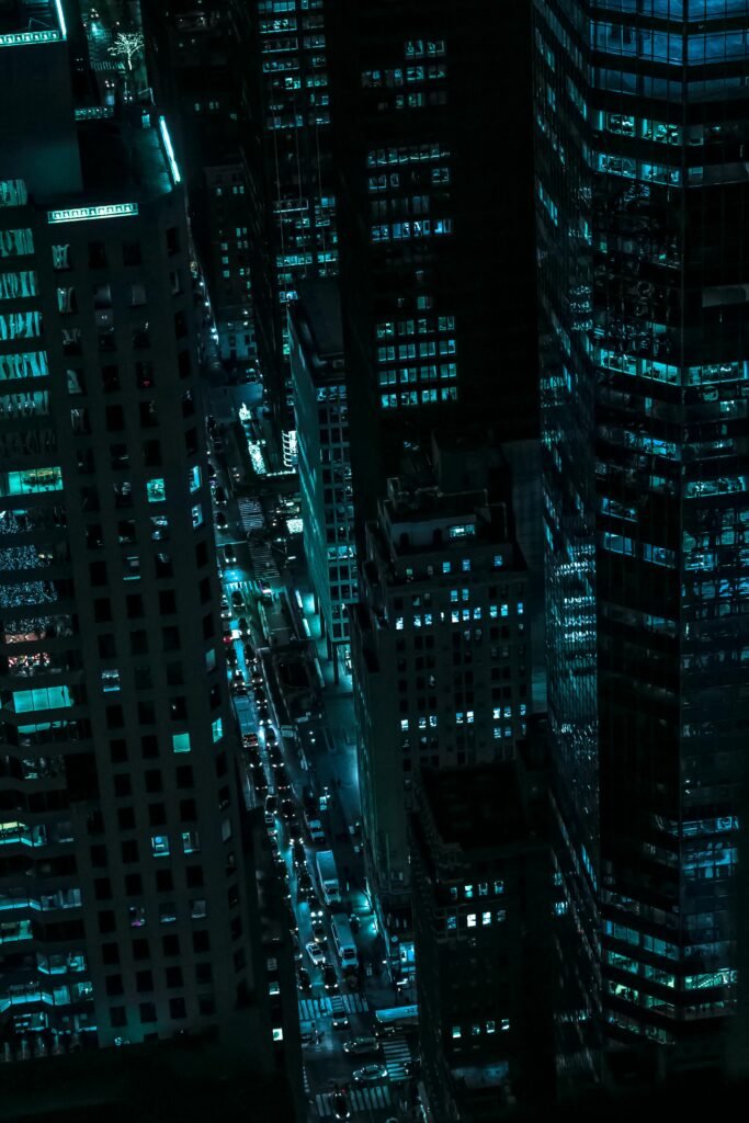 Captivating aerial view of illuminated skyscrapers in New York City during the night.