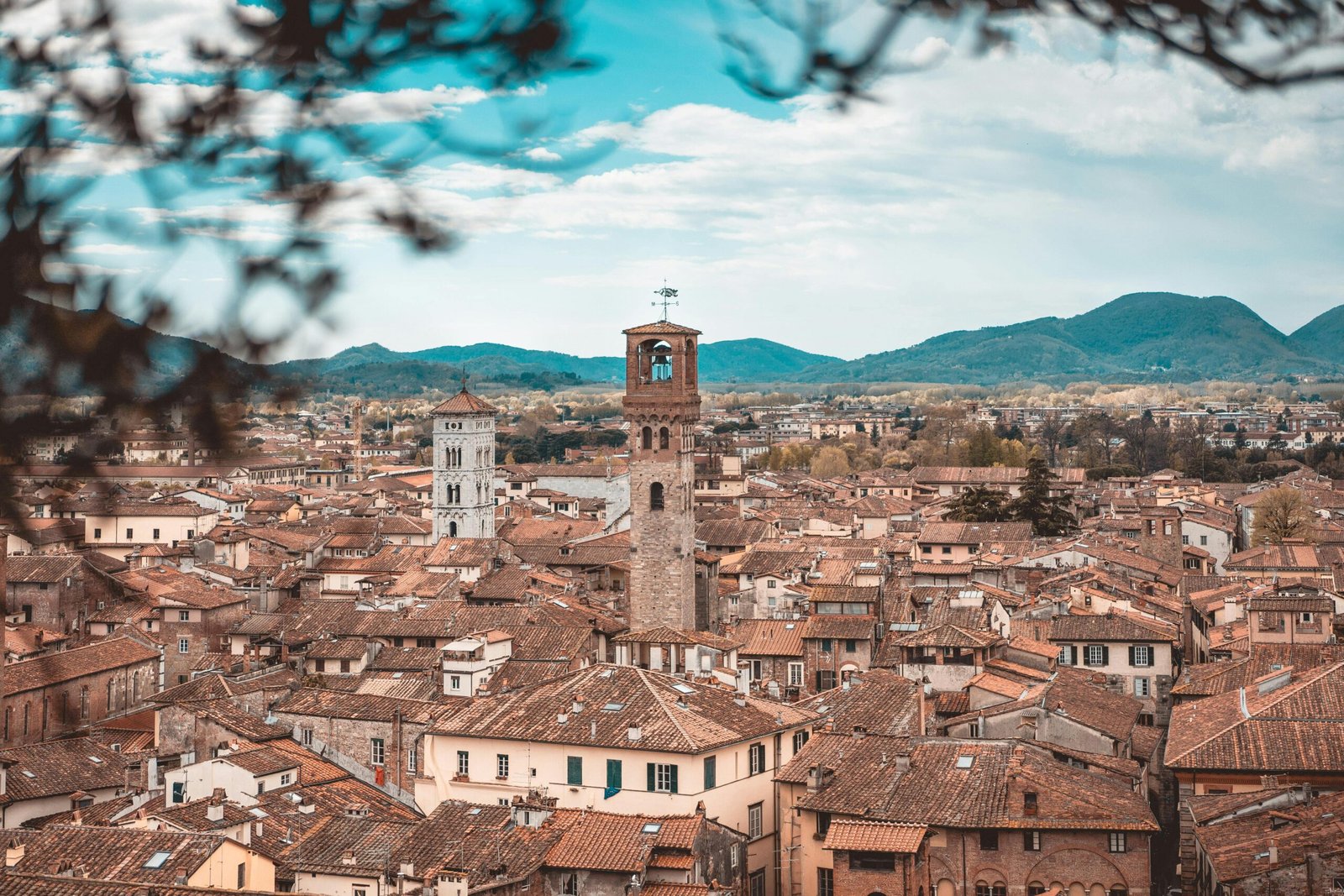 pexels-photo-2277435-2277435 Charming aerial view of Lucca's historic buildings and clock towers in Tuscany.