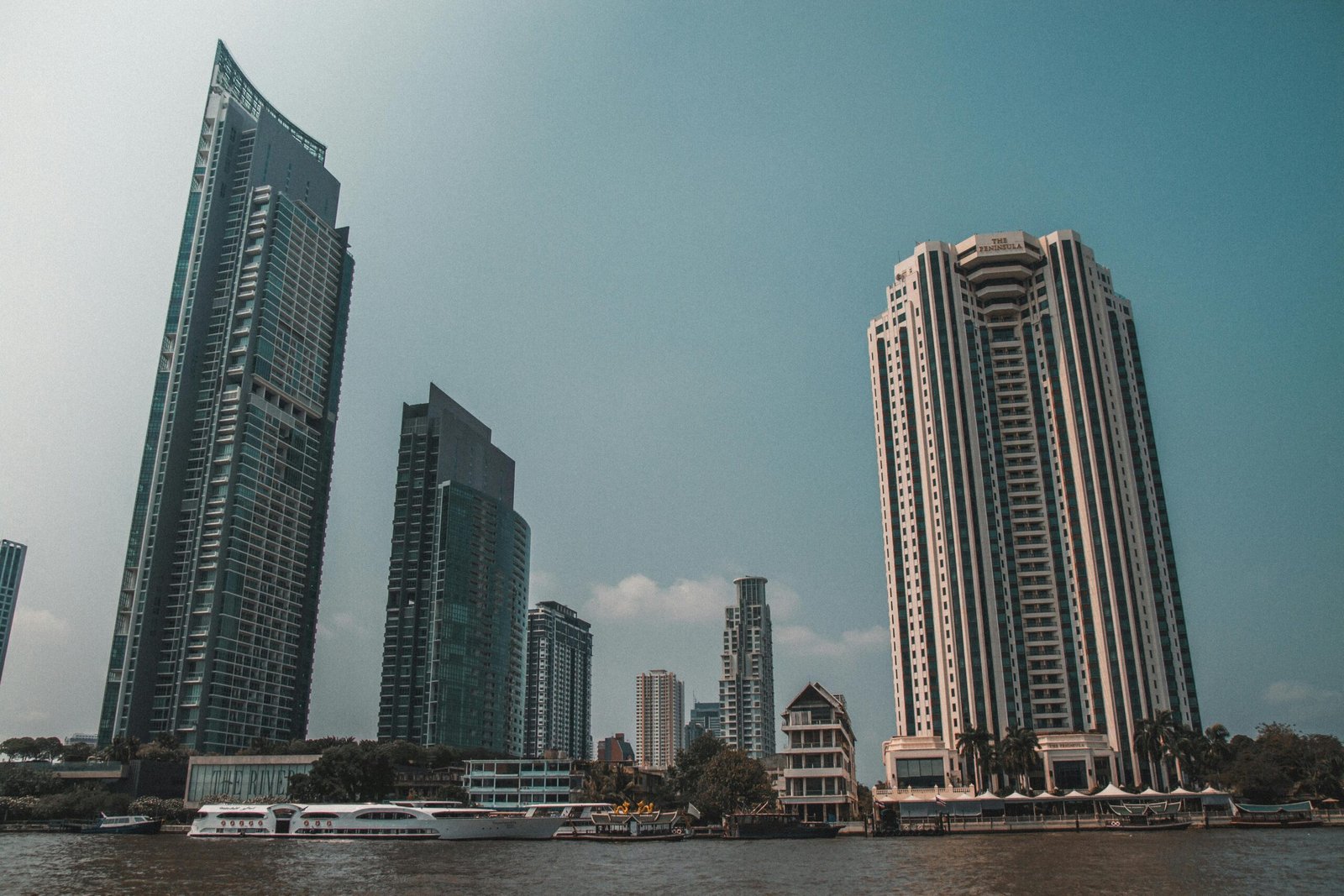 pexels-photo-2297090-2297090 Panoramic view of Bangkok's waterfront with skyscrapers under a clear sky.