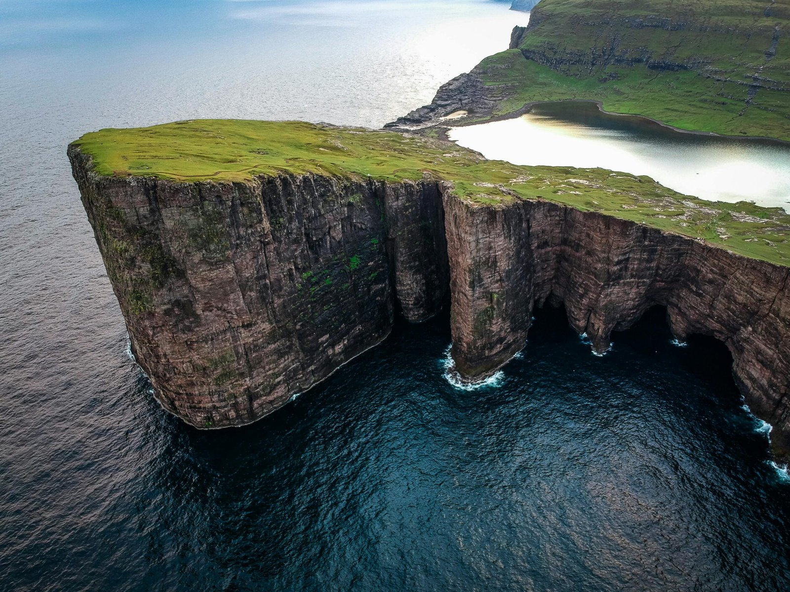 pexels-photo-2581853-2581853 A breathtaking aerial shot of the dramatic cliffs of Sørvágsvatn against the ocean in Faroe Islands.