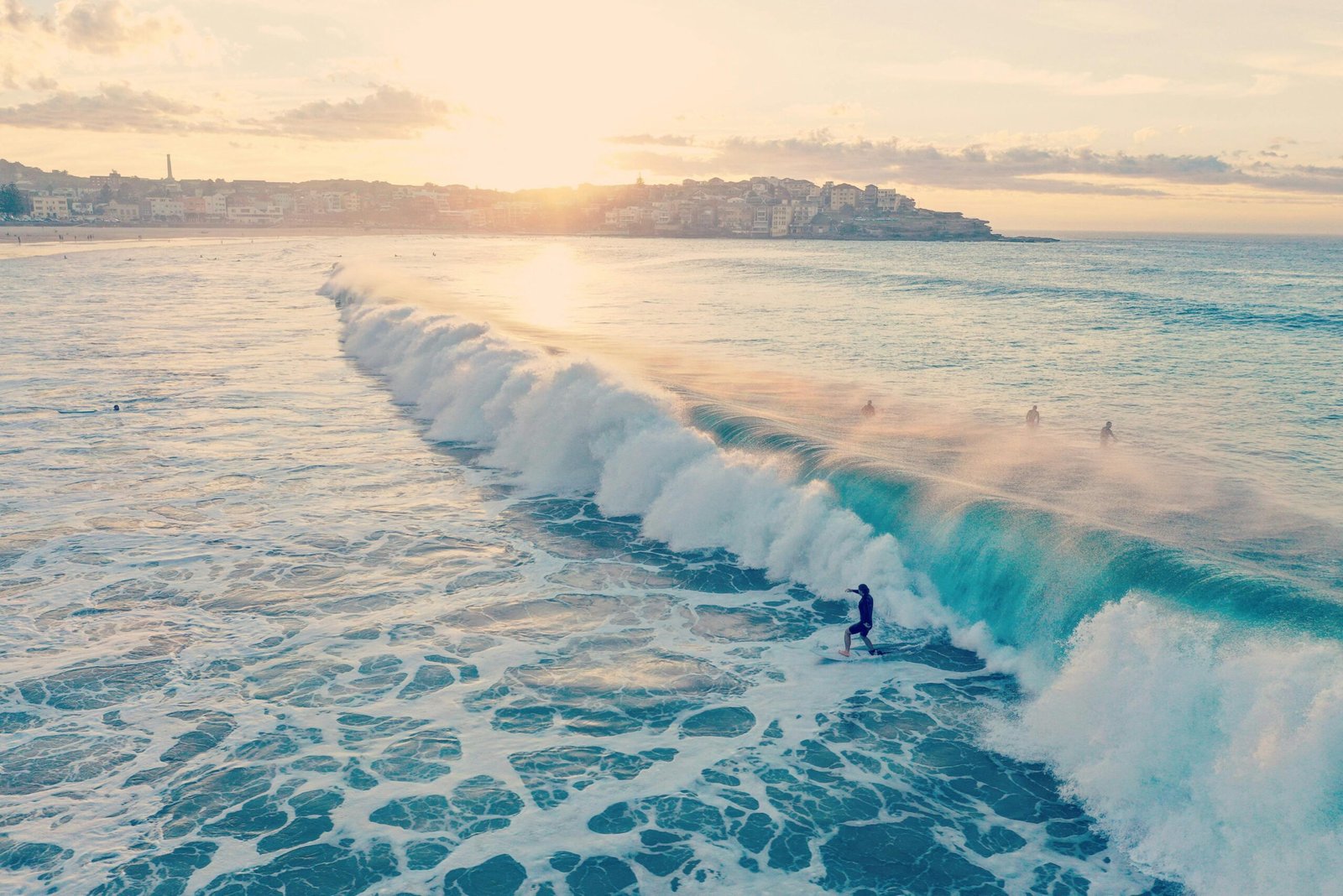 pexels-photo-2607830-2607830 Surfers ride waves at Bondi Beach during a beautiful summer sunset in Australia.