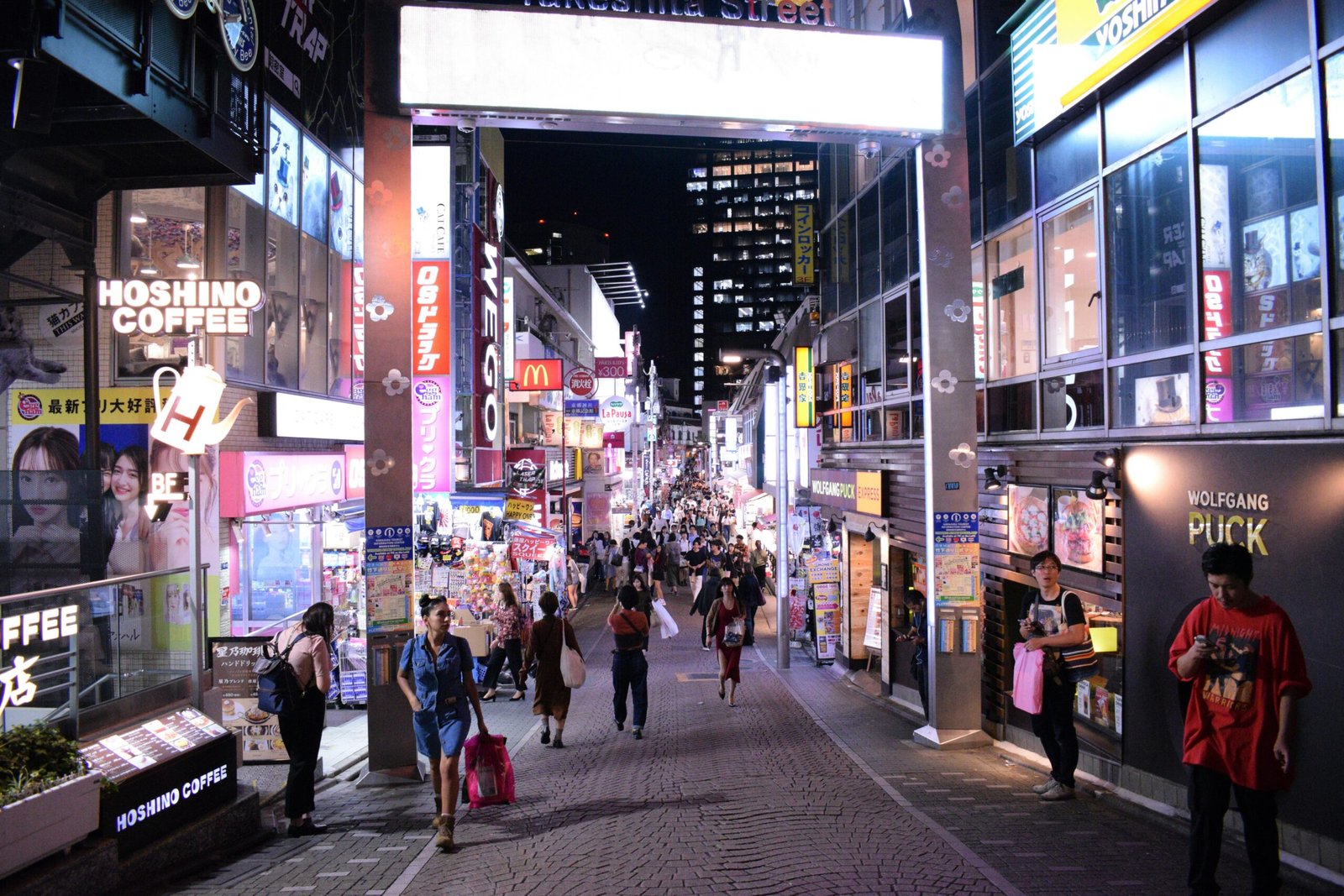 pexels-photo-27945361-27945361 Bustling nightlife on Takeshita Street, Tokyo, showcasing vibrant neon signs and a lively crowd.
