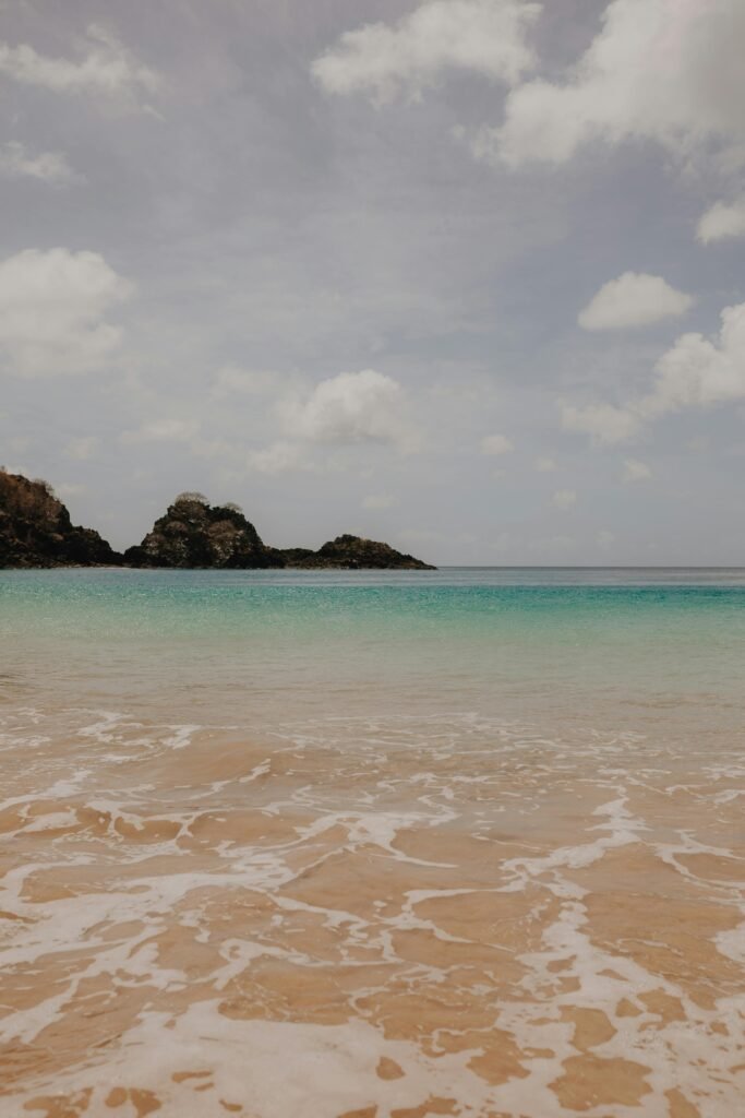 Discover tranquility at a serene tropical beach with clear turquoise waters and gentle waves.