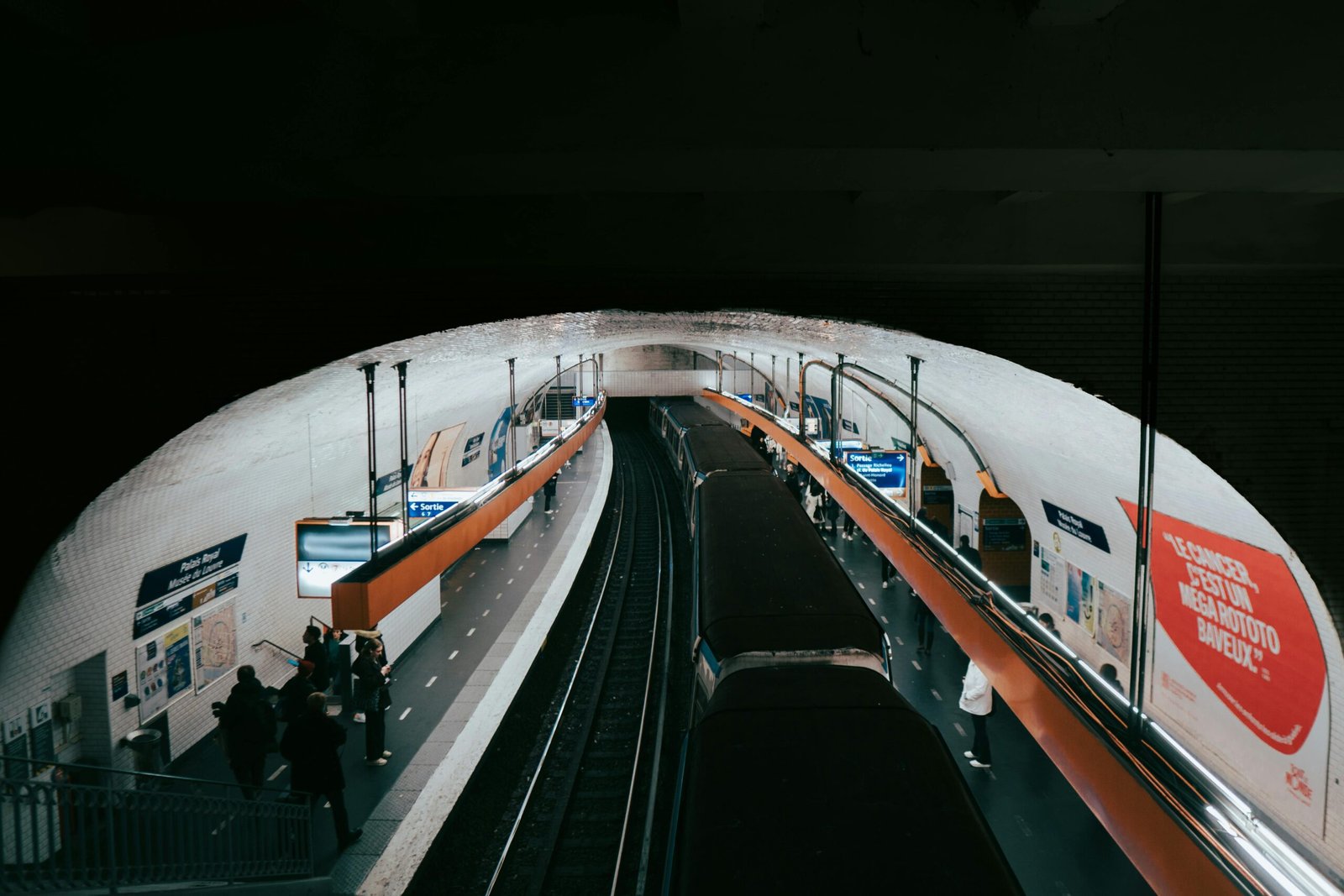 A busy Paris metro station captured with commuters waiting for their train.