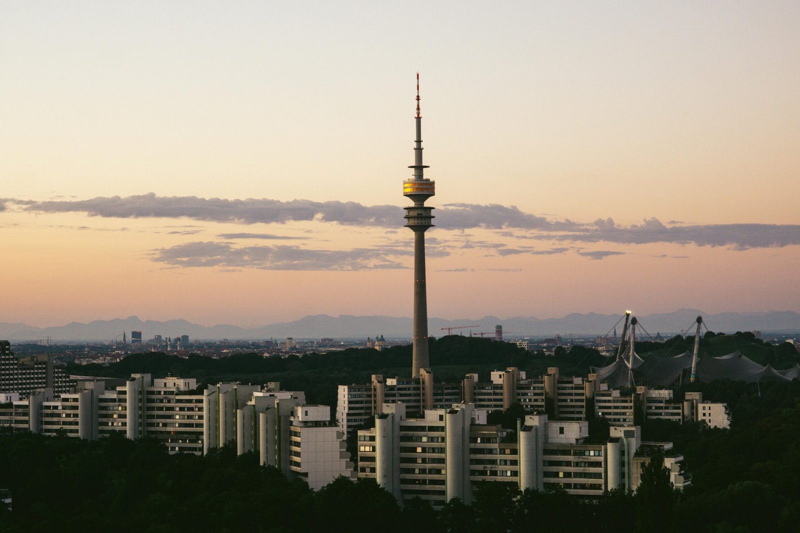 pexels-photo-31592951-31592951 Capture of Munich's skyline featuring the prominent Olympia Tower at dusk with a serene sky.