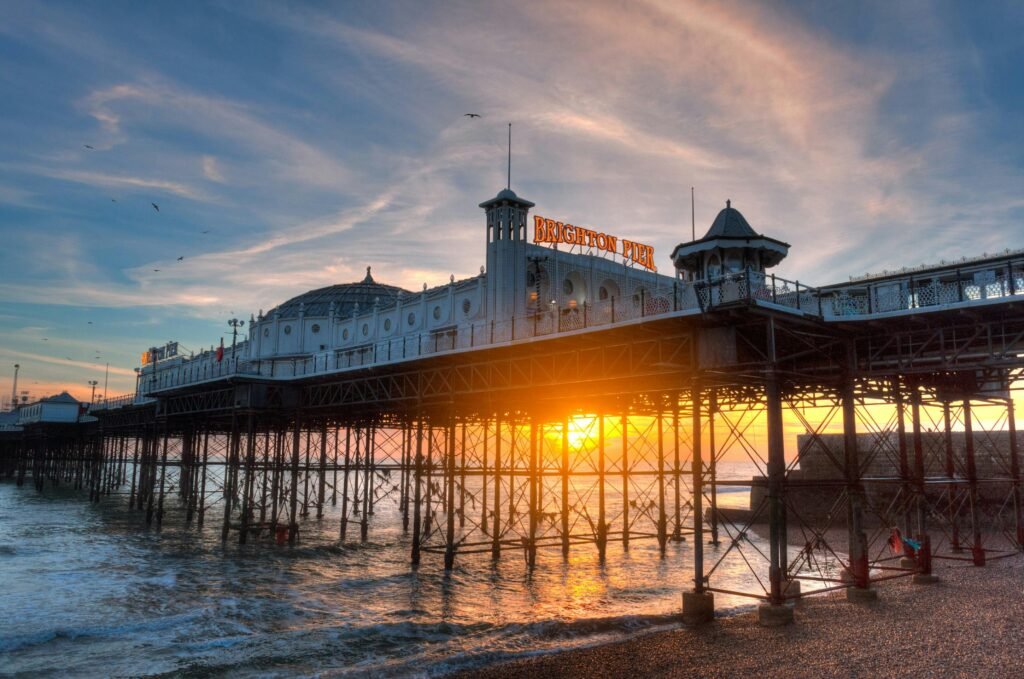 pexels-photo-3224151-3224151-1 Sunset view of Brighton Pier with its iconic architecture against the vibrant sky and ocean.