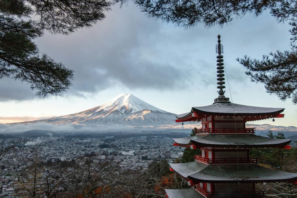 pexels-photo-3408354-3408354 Scenic view of Chureito Pagoda with snow-capped Mount Fuji under a cloudy sky in Fujinomiya, Japan.