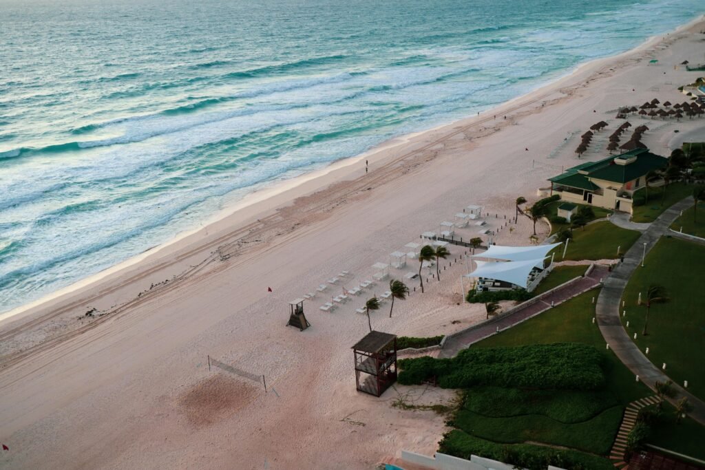 pexels-photo-3651084-3651084 Serene aerial view of Cancun's beautiful beachfront with turquoise waters and sandy shores.