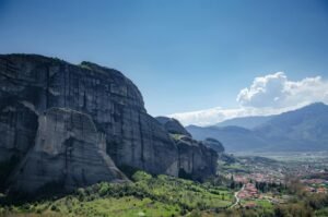 Stunning view of Meteora rock formations and landscape in Greece on a sunny day.