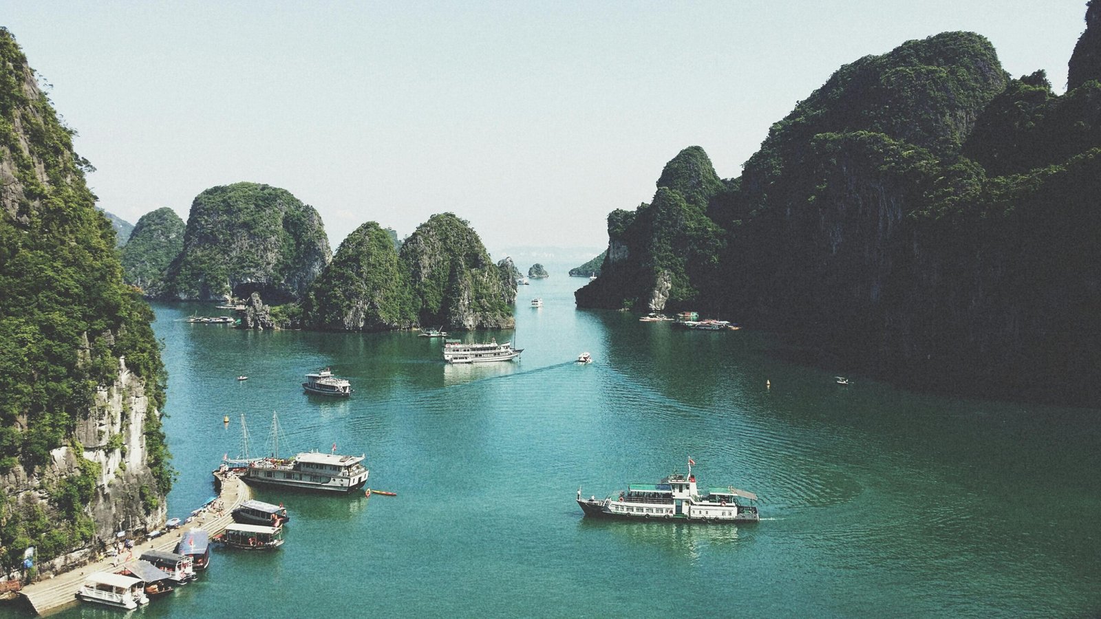 pexels-photo-58597-58597 A breathtaking view of Halong Bay with boats navigating through limestone islands.