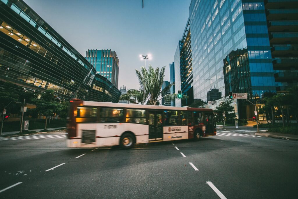 pexels-photo-68427-68427 Dynamic city scene featuring a bus in motion amidst modern urban architecture at twilight.