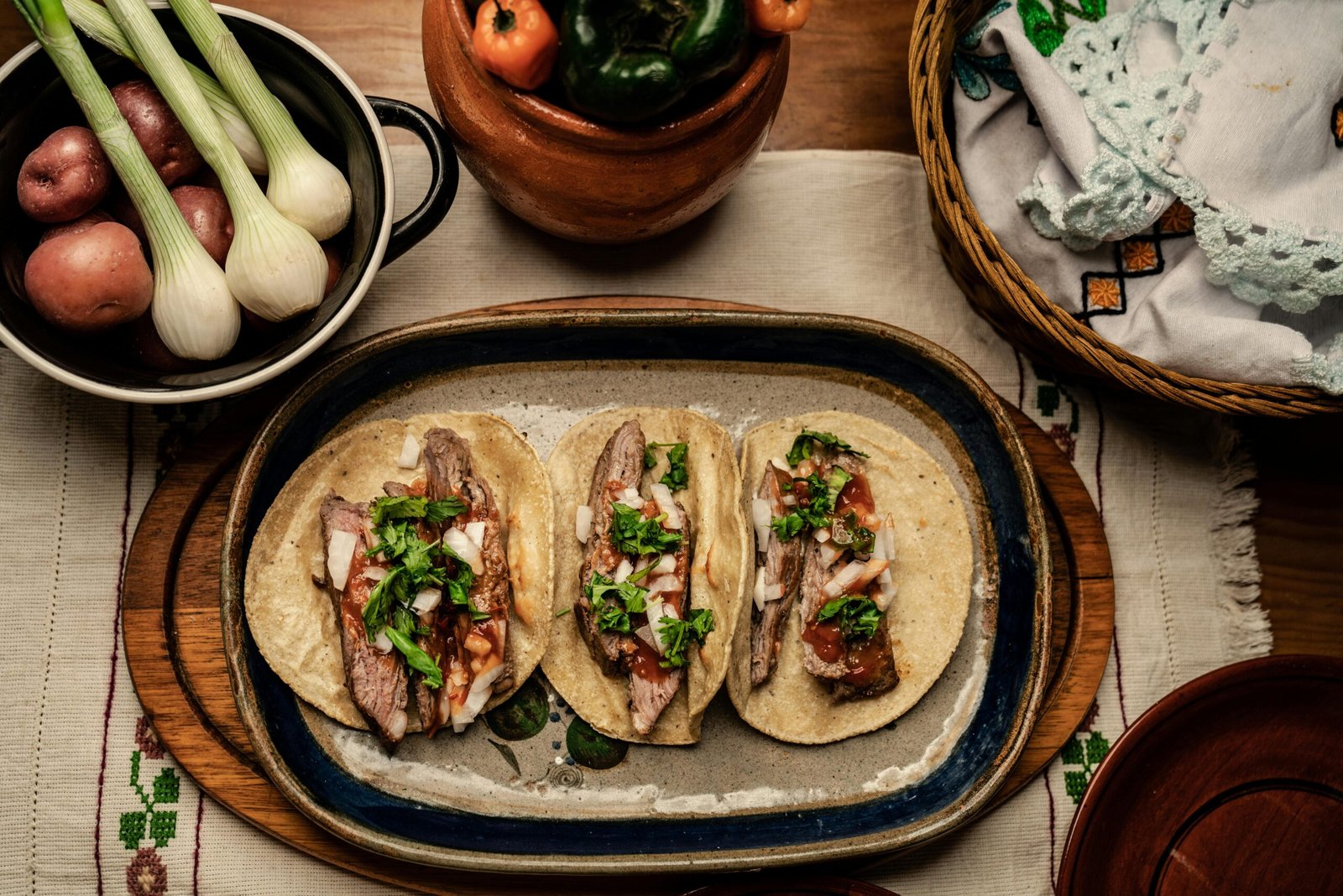 pexels-photo-7613556-7613556 A flavorful platter of Mexican tacos with fresh vegetables, perfect for a traditional meal.