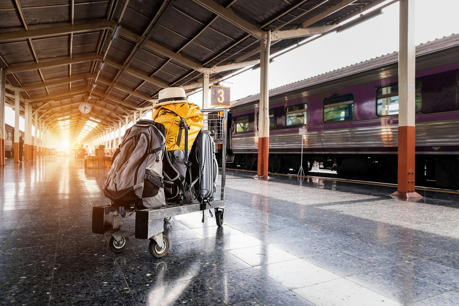 pexels-photo-1170187-1170187 A traveler's baggage cart on an urban railway station platform at sunrise.