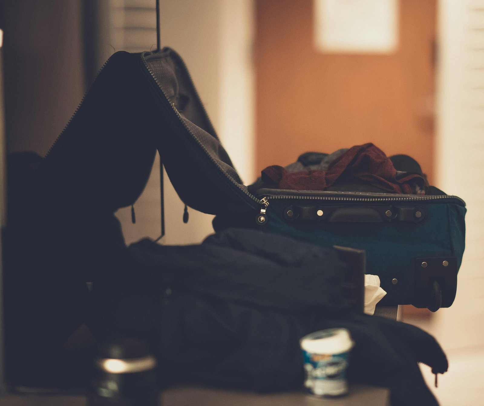 pexels-photo-1682694-1682694 A warm-toned indoor image of an open suitcase with clothes, conveying travel readiness.