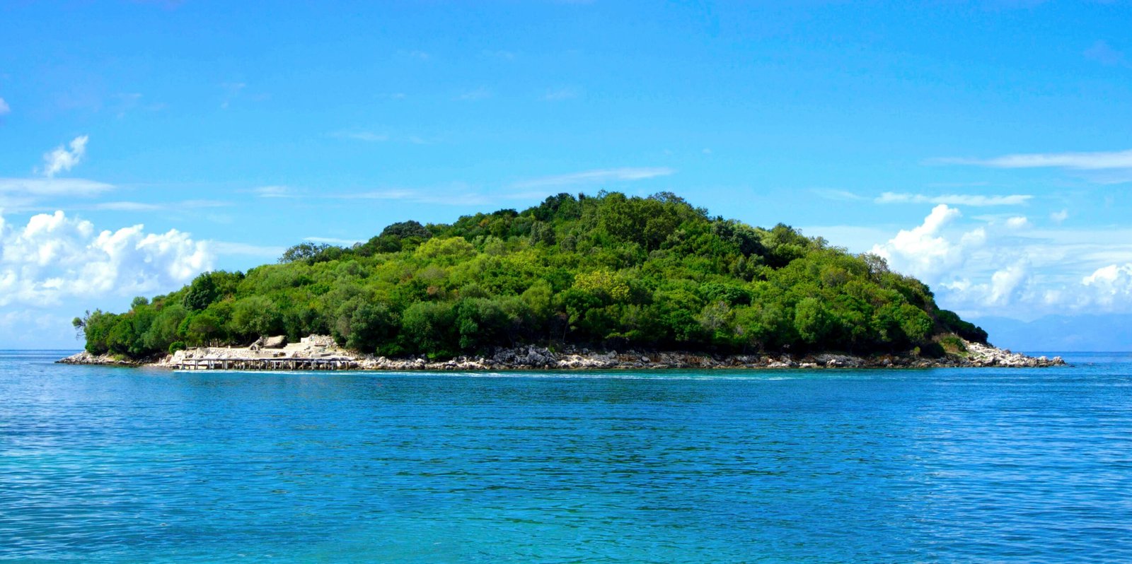 pexels-photo-188029-188029 Scenic view of lush island surrounded by clear blue sea in Ksamil, Albania.