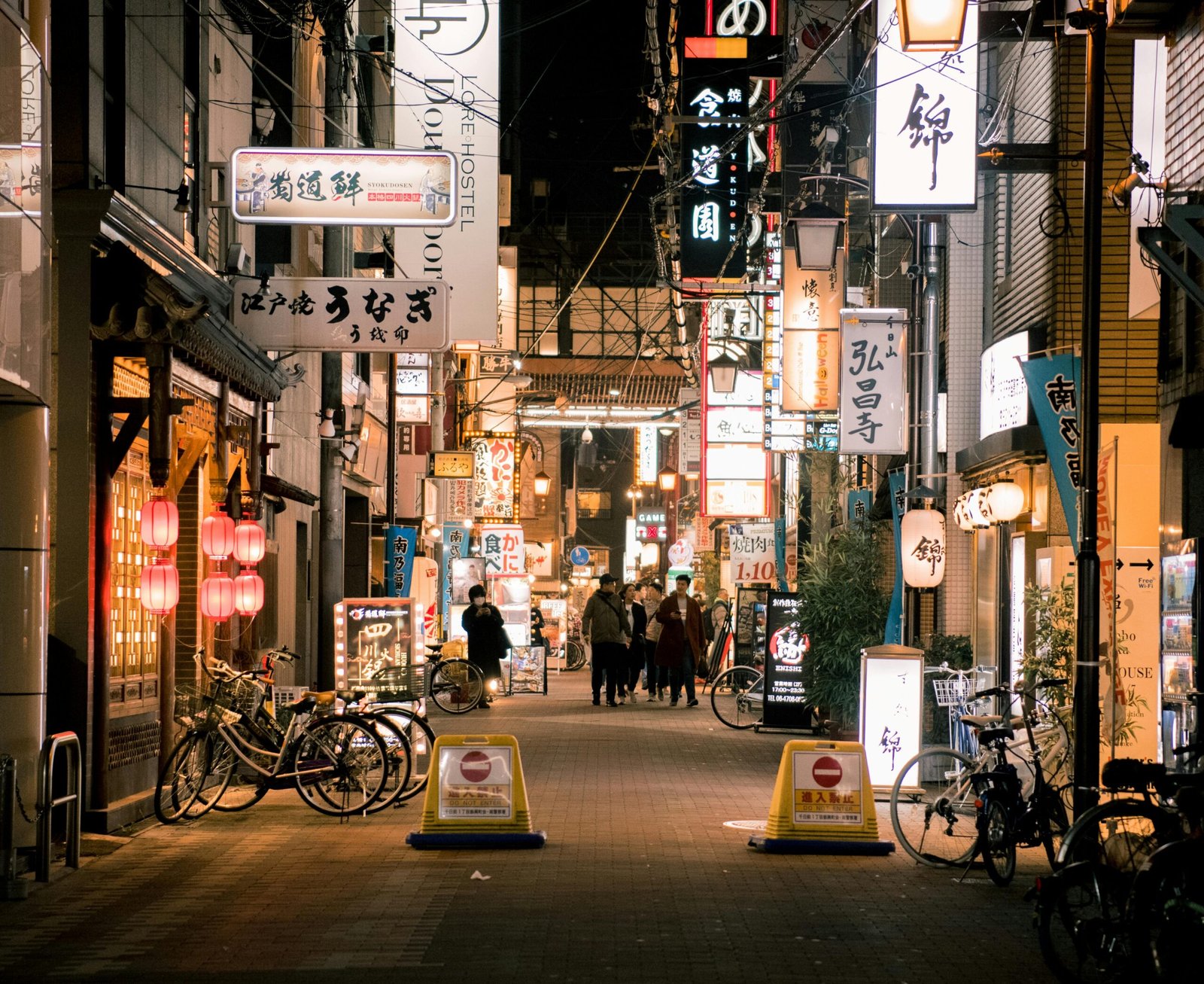 pexels-photo-1979828-1979828 Bustling evening scene of Osaka's vibrant shopping street with illuminated signs and people walking.