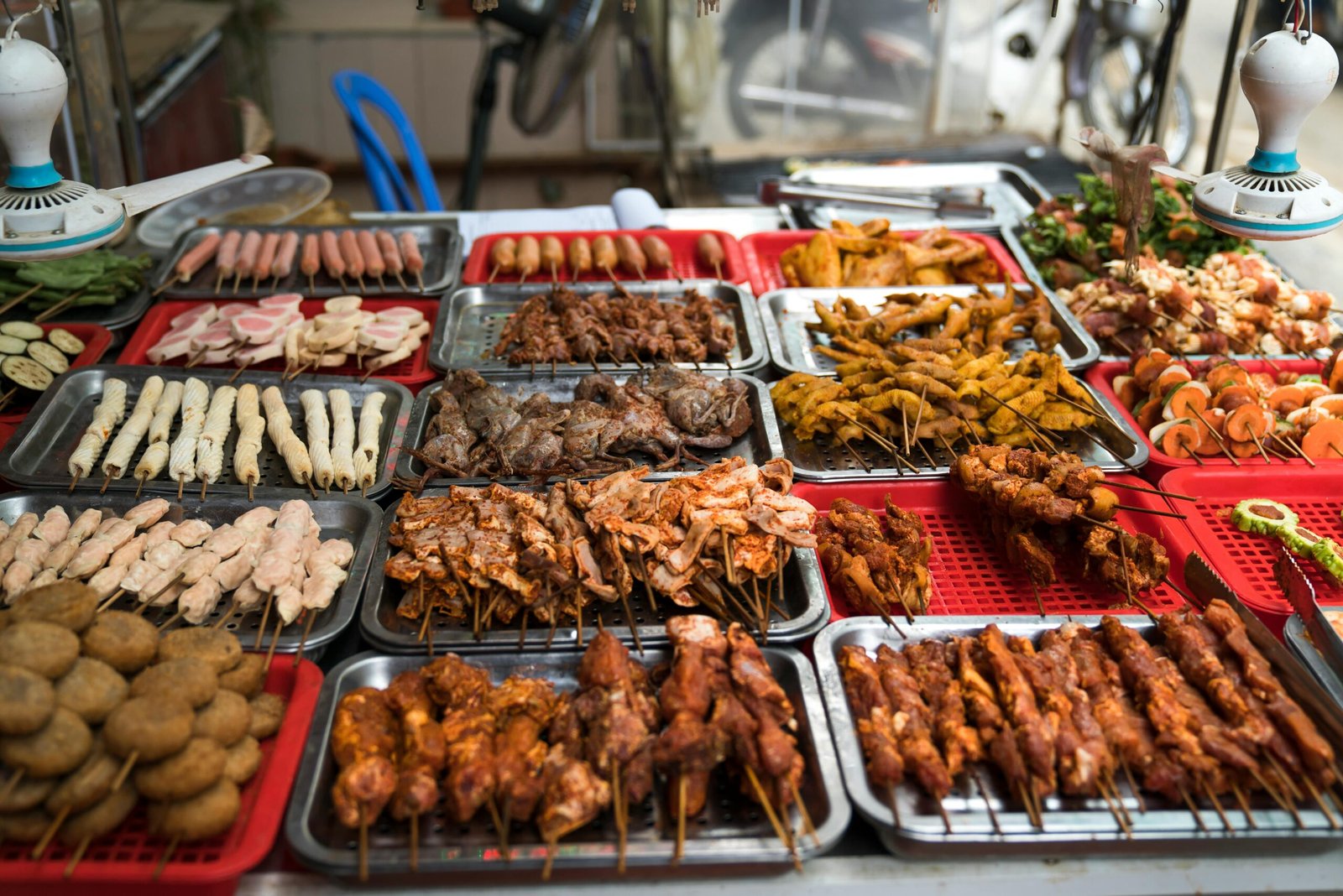 pexels-photo-2165159-2165159 A colorful assortment of grilled street food skewers on display, showcasing various meats and vegetables.