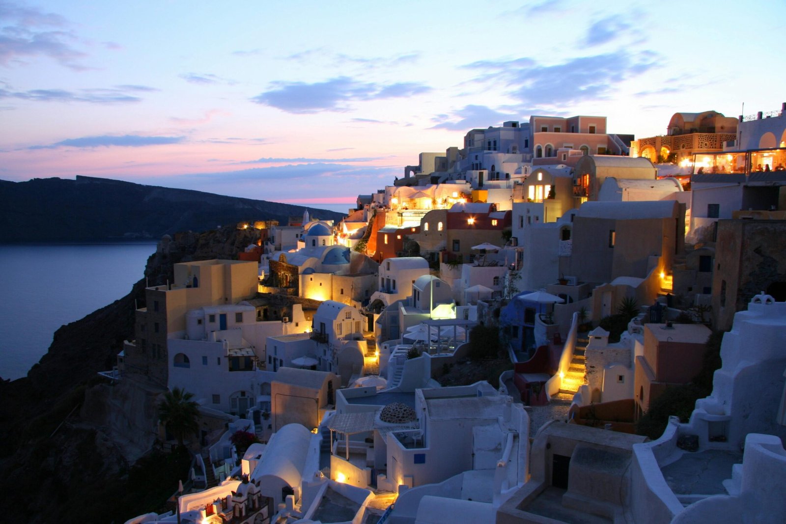 pexels-photo-221532-221532 Beautiful illuminated cityscape of Santorini at dusk overlooking the Aegean Sea.