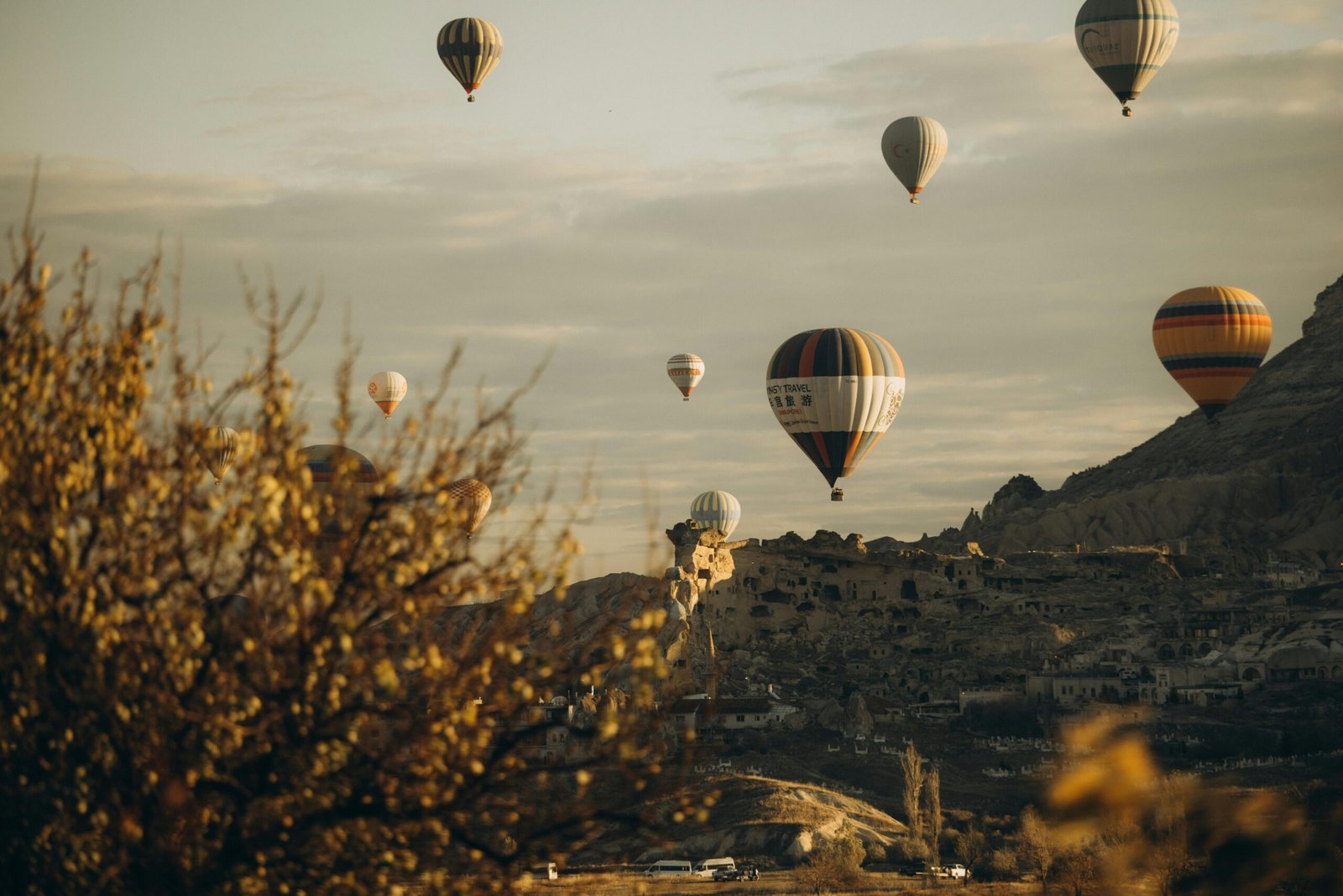 pexels-photo-24877150-24877150 Scenic view of colorful hot air balloons soaring over the unique Cappadocia landscape at sunrise.