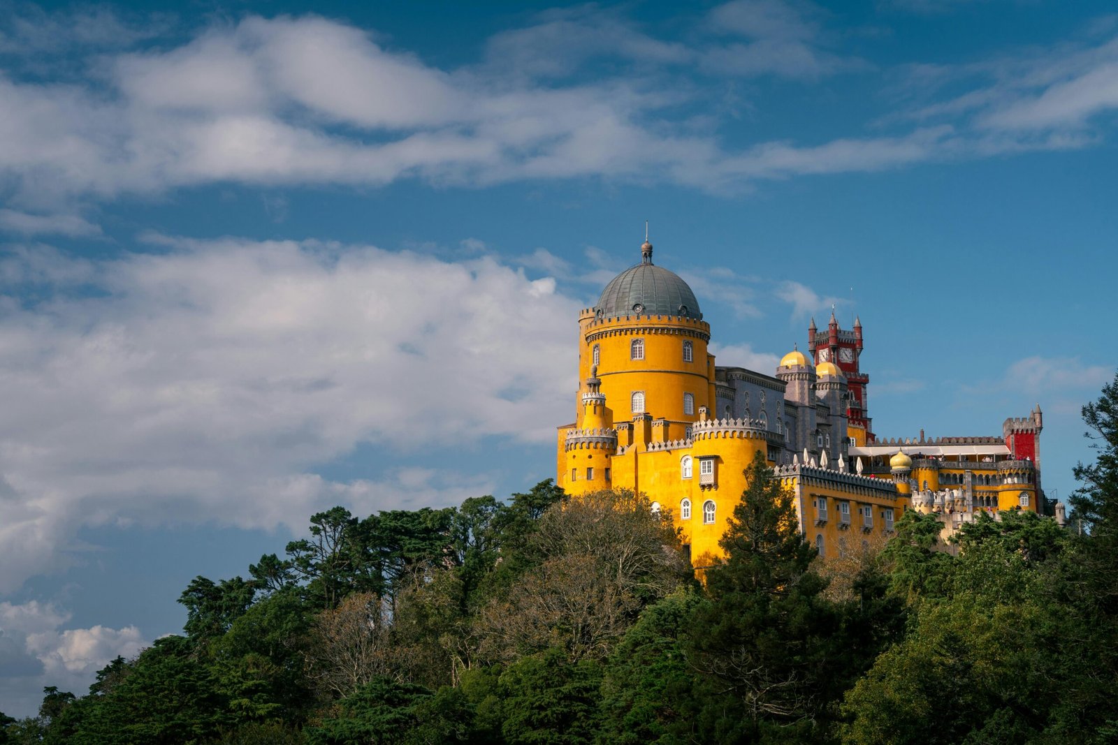 pexels-photo-30912269-30912269 Stunning view of the colorful Pena Palace in Sintra, Portugal on a sunny day.