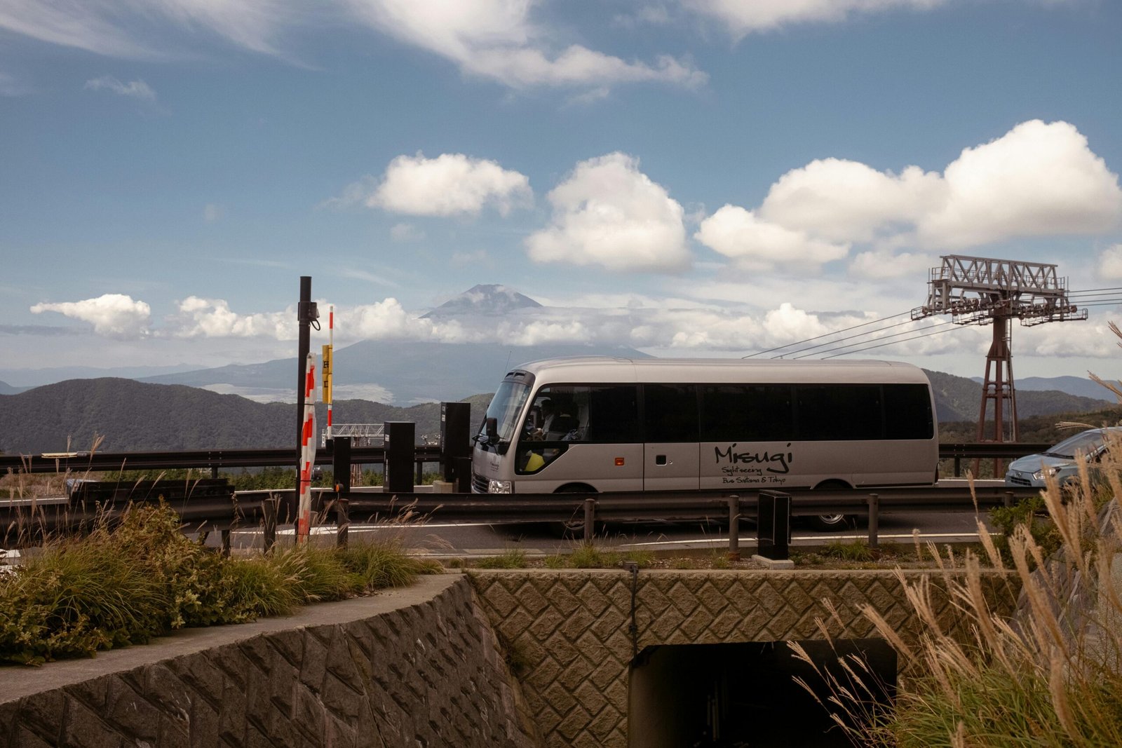 pexels-photo-31418840-31418840 Tourist bus traveling in Hakone with Mount Fuji backdrop on a clear day.