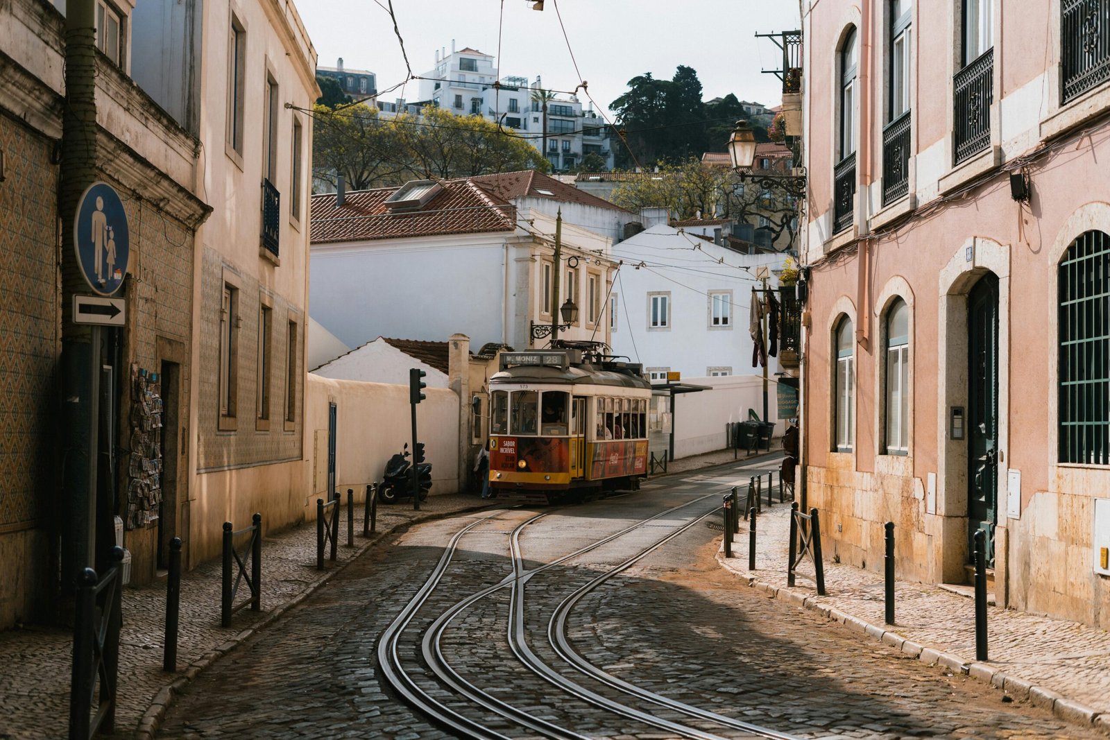 pexels-photo-31800279-31800279 A classic tram navigating the scenic streets of Lisbon, Portugal, under a sunny day.