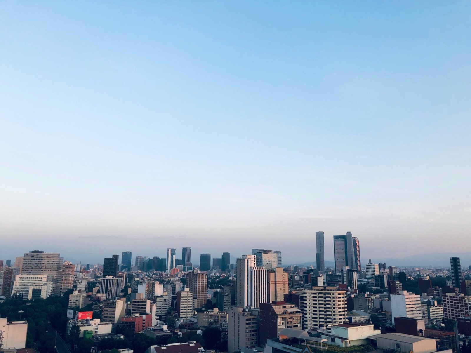 pexels-photo-3579433-3579433 Beautiful aerial view of Mexico City's skyline with skyscrapers under a clear blue sky.