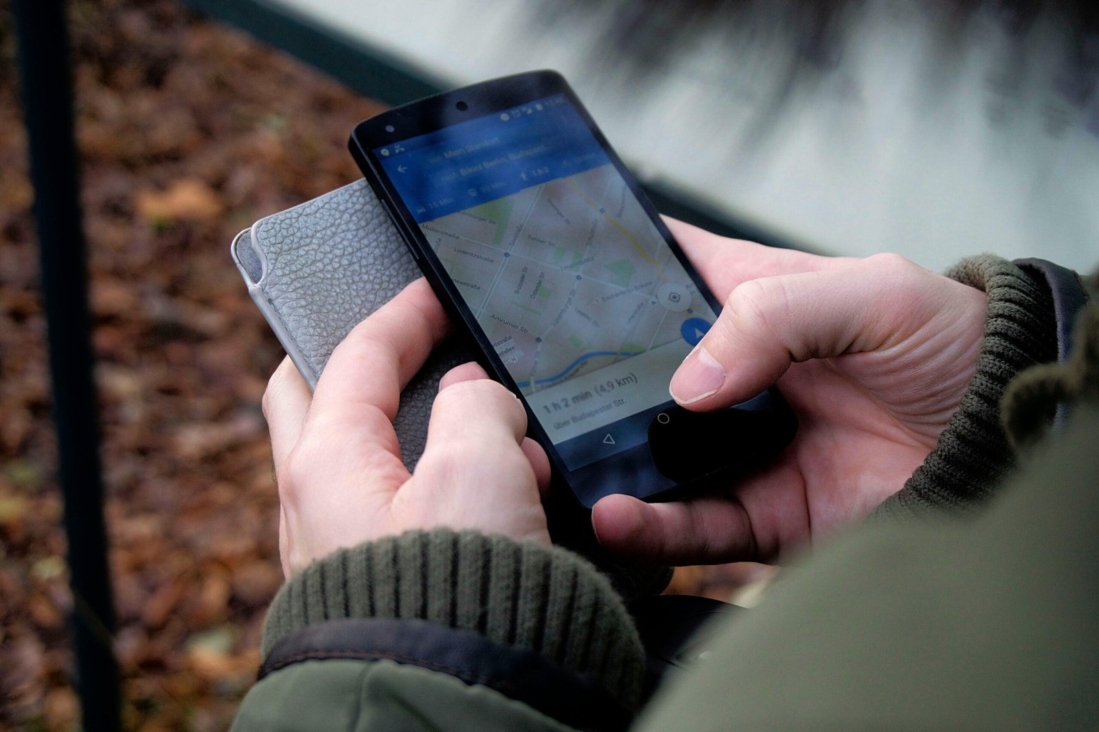 pexels-photo-35969 Close-up of hands using a map app on a smartphone outdoors, showcasing GPS navigation.