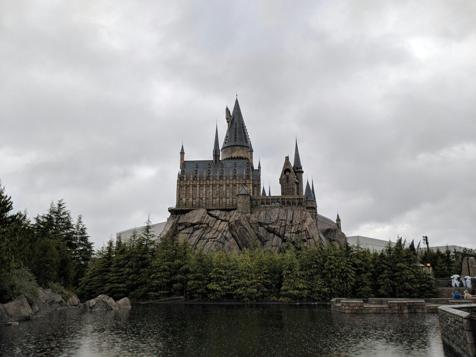 pexels-photo-5432843-5432843 Majestic exterior view of Hogwarts Castle at Universal Studios Japan with a scenic water reflection.