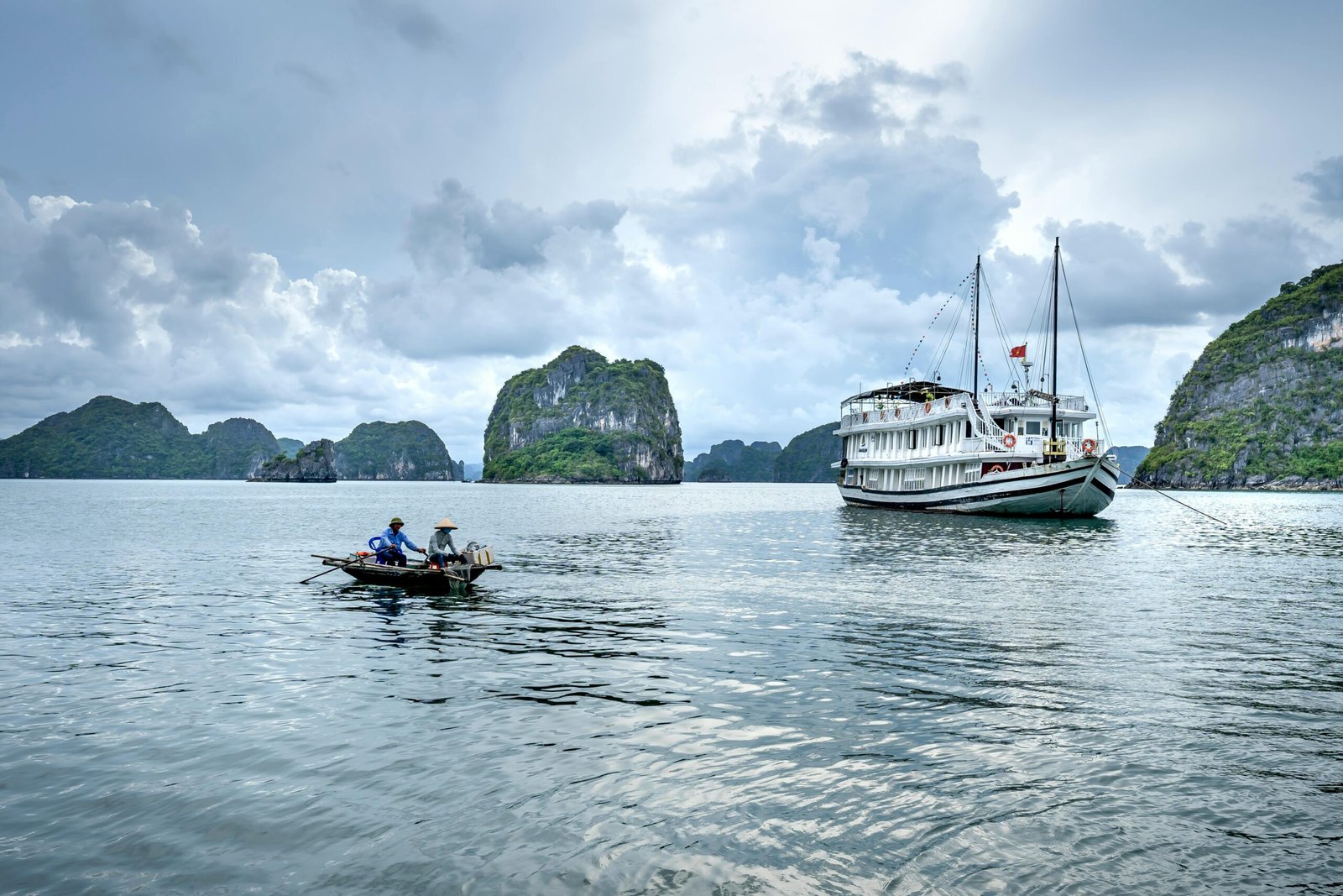 pexels-photo-6871170-6871170 A serene view of fishing boats near limestone islands in Ha Long Bay, Vietnam.