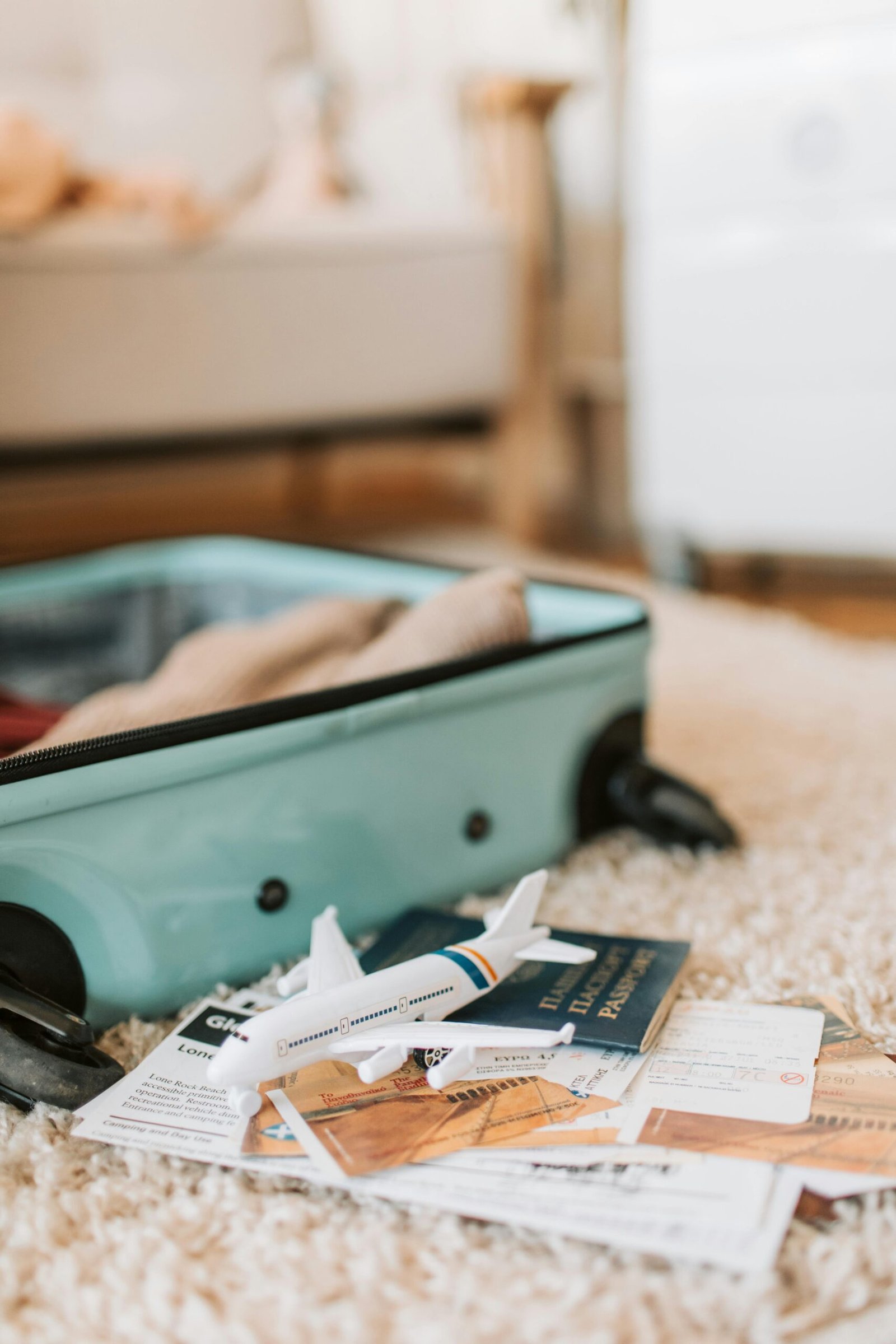 pexels-photo-7368202-7368202 Open suitcase with travel documents and a toy plane, evoking a sense of adventure.