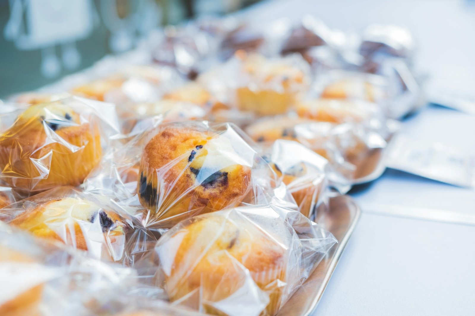 pexels-photo-7694561-7694561 Close-up of blueberry muffins neatly wrapped in plastic in a Tokyo bakery, showcasing delicious pastries.