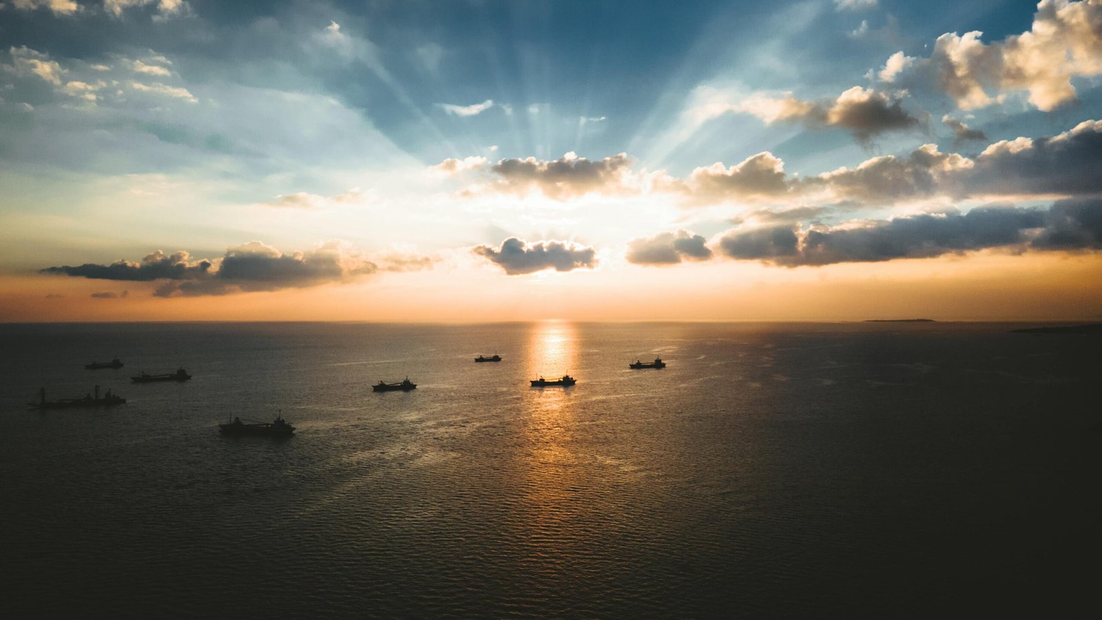 pexels-photo-9808278-9808278 Breathtaking aerial view of ships on the ocean during a stunning sunset in Okinawa, Japan.