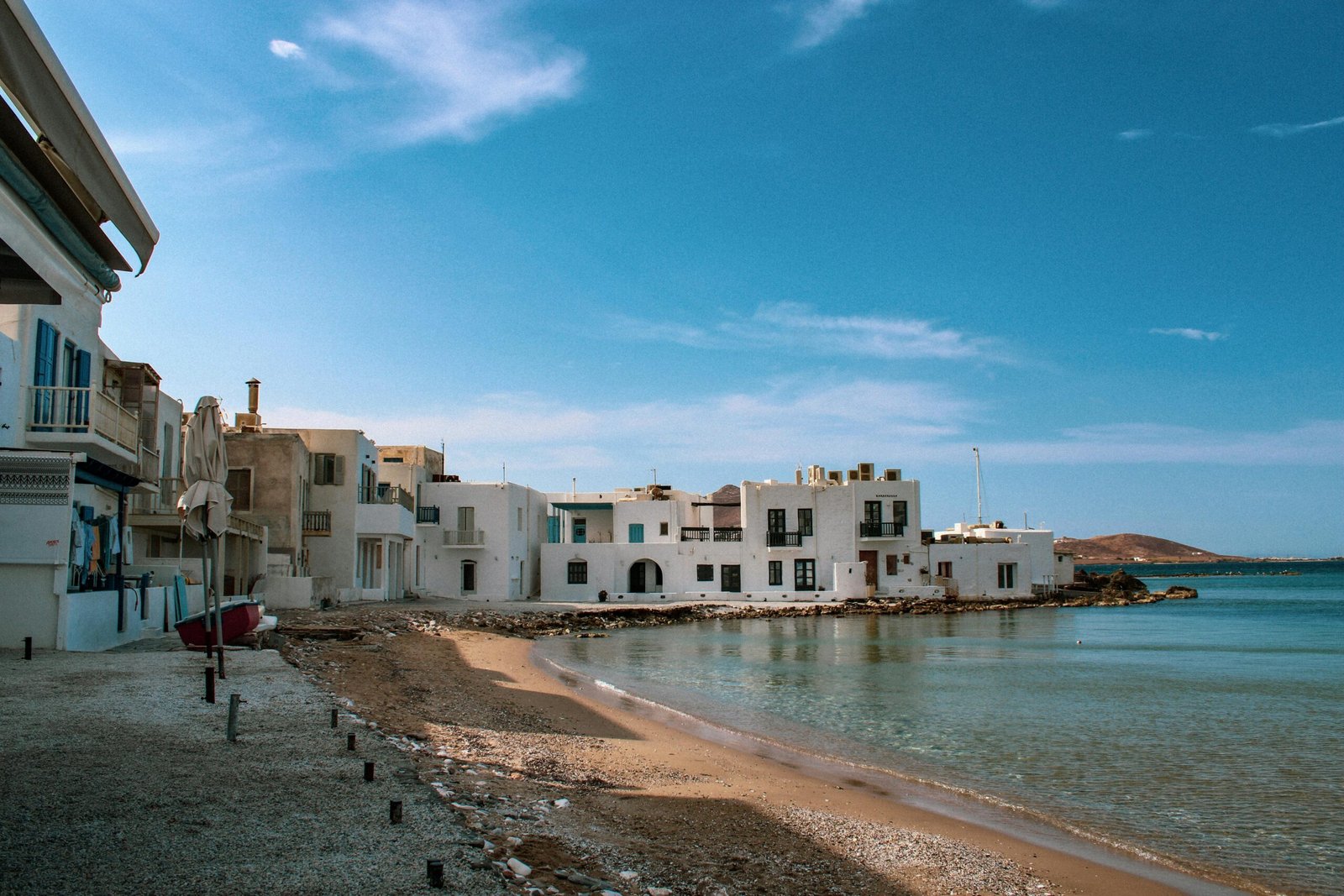 pexels-photo-9883703-9883703 Scenic view of traditional white architecture by the clear blue sea in Naoussa, Paros Island, Greece.