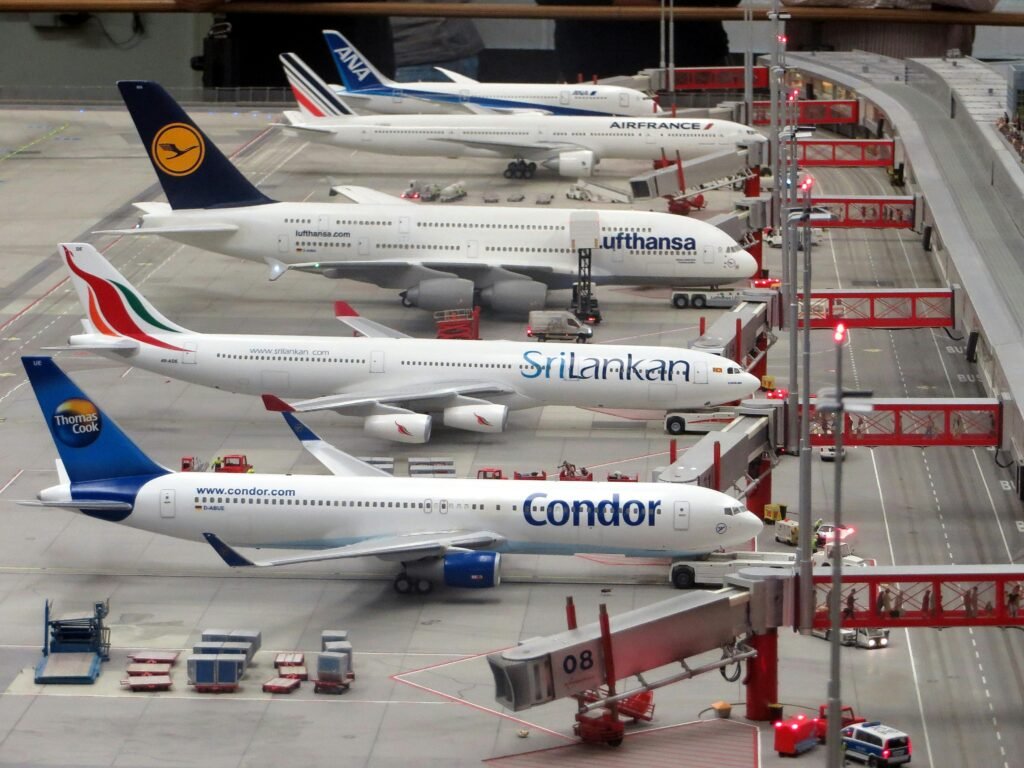 model-planes-airplanes-miniatur-wunderland-hamburg-163792-163792 Detailed miniature model of an airport terminal with various aircraft brands on display.