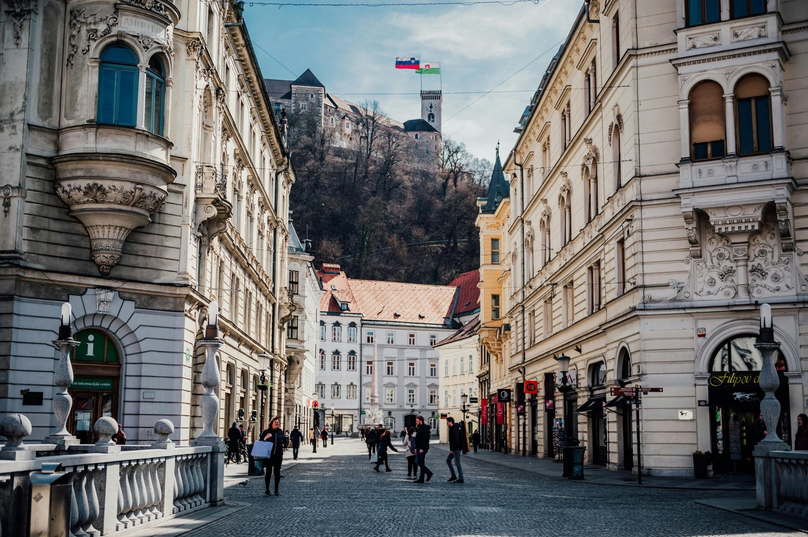 pexels-photo-11487781-11487781 Stroll through a historic street in Ljubljana, Slovenia, with a view of the castle atop the hill.