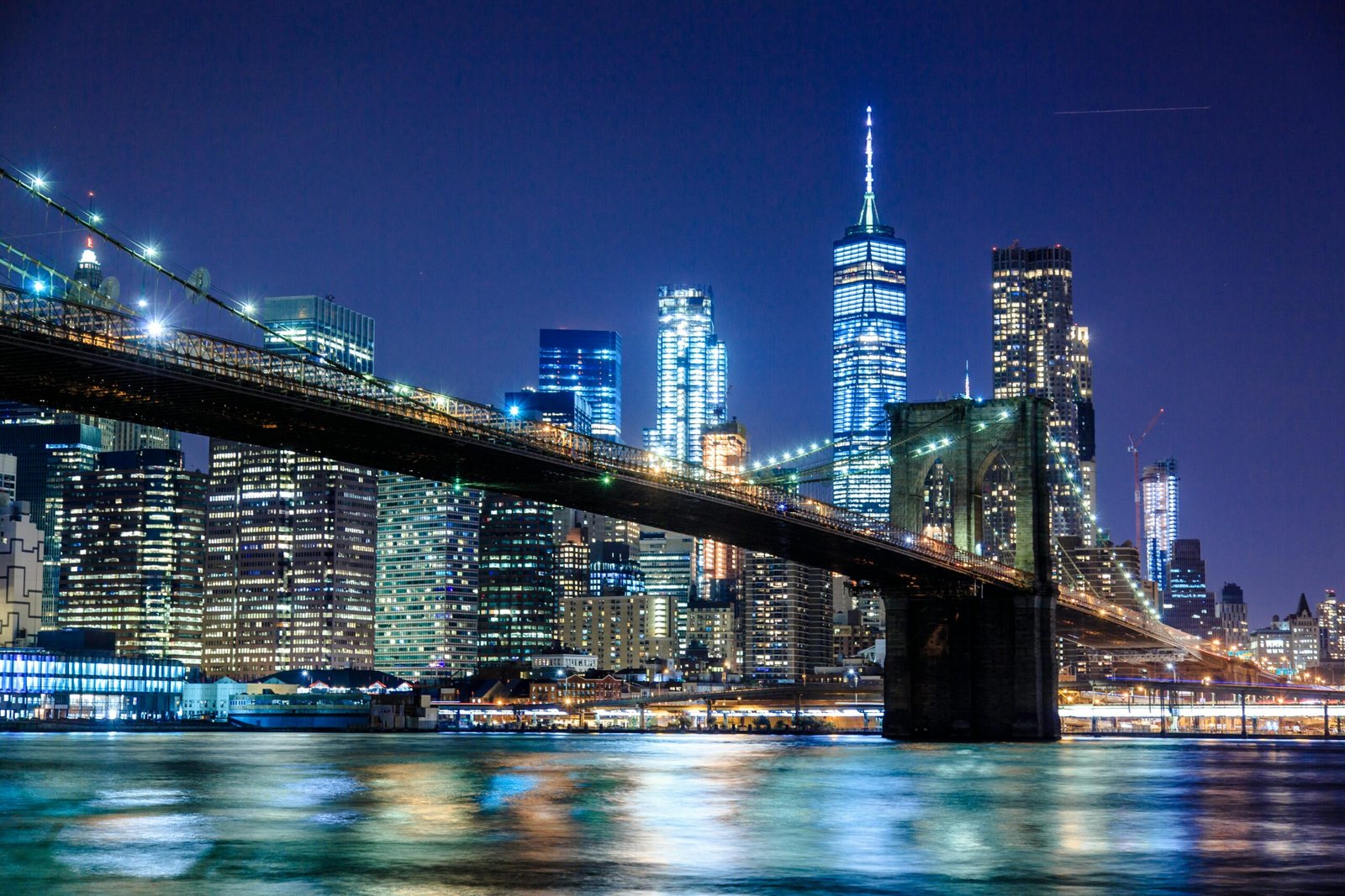 pexels-photo-1239162-1239162 Stunning view of the Brooklyn Bridge and New York City skyline illuminated at night.