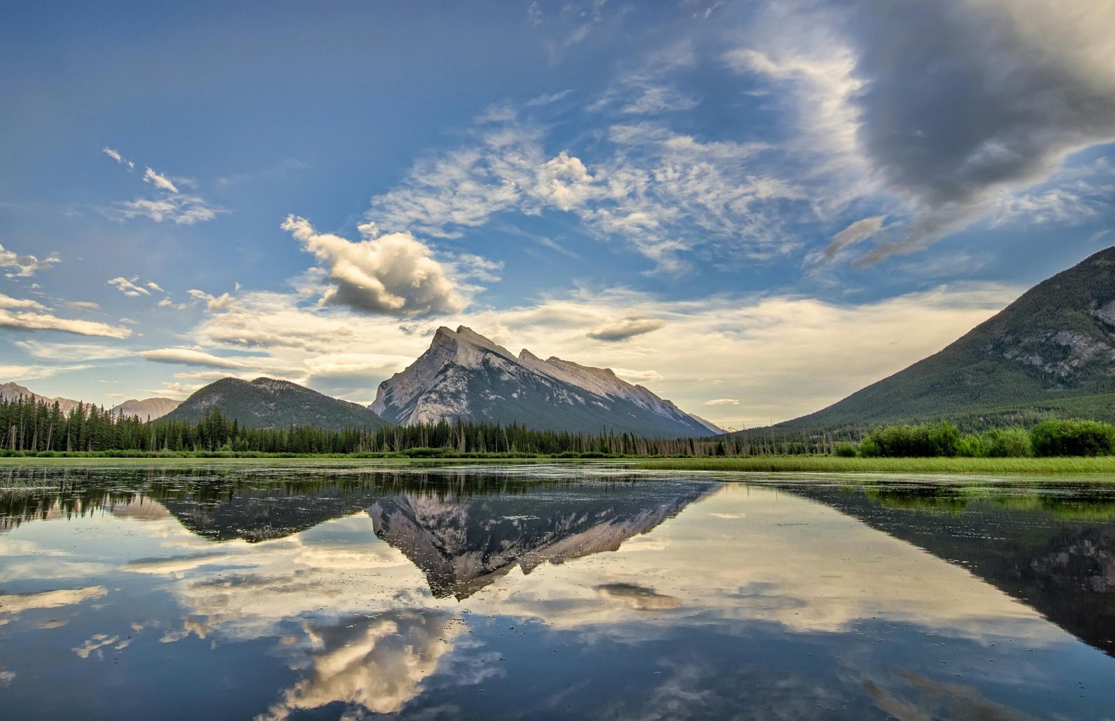 pexels-photo-1592461-1592461 Serene landscape of Banff National Park with mountains and lake reflections at sunrise.
