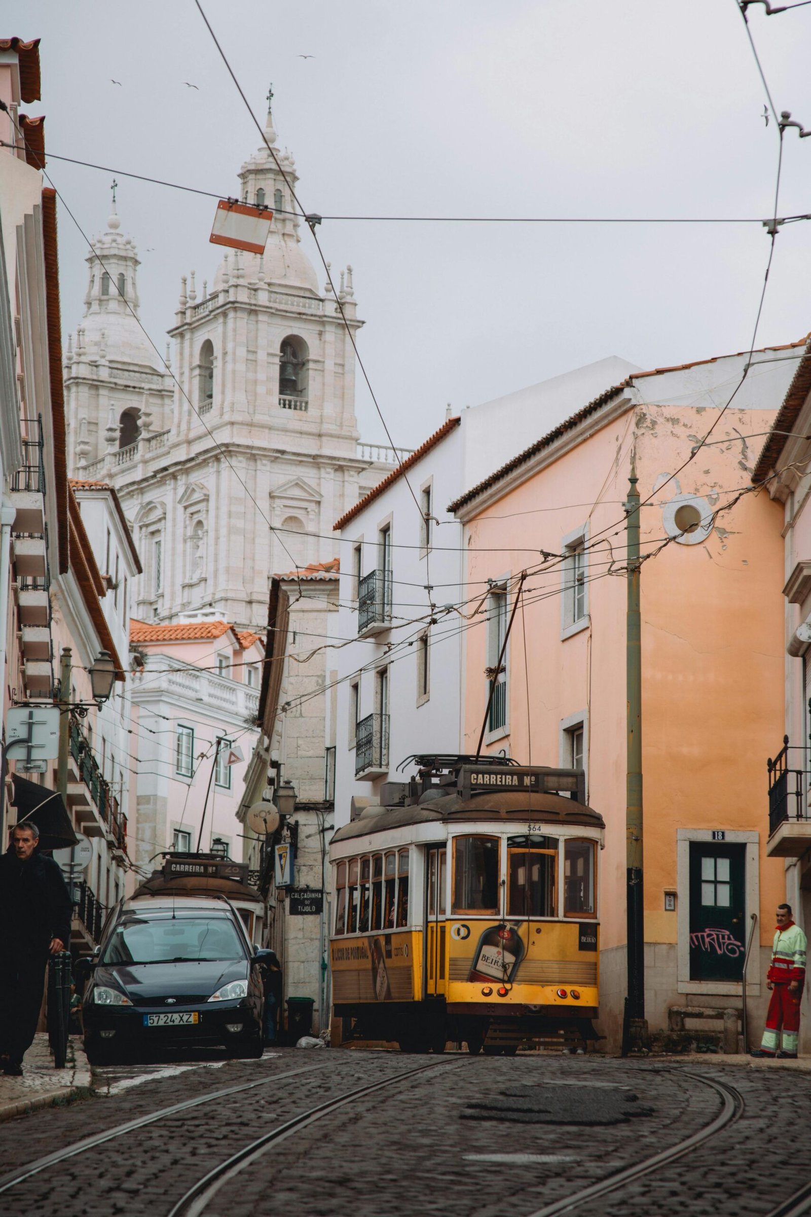 pexels-photo-19560855-19560855 Lisbon's iconic Tram 28 passing through the historic streets near São Vicente de Fora in Portugal.