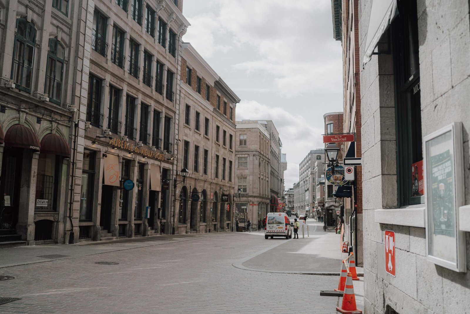 pexels-photo-20788319-20788319 A peaceful street scene in historic Old Montreal with classic architecture under a cloudy sky.