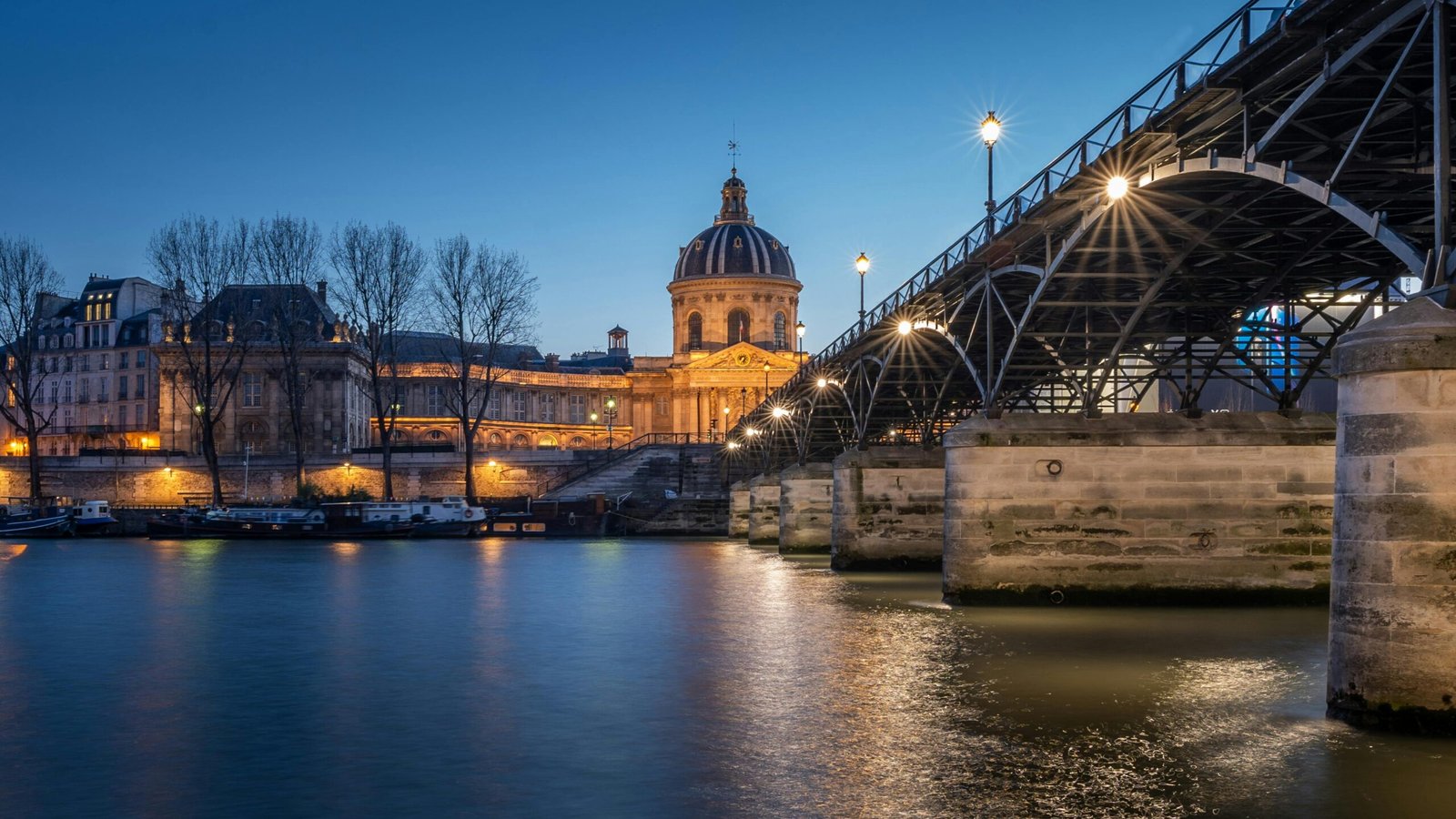 pexels-photo-2389280-2389280 Scenic twilight view of Institut de France and Pont des Arts in Paris with reflections on the Seine River.