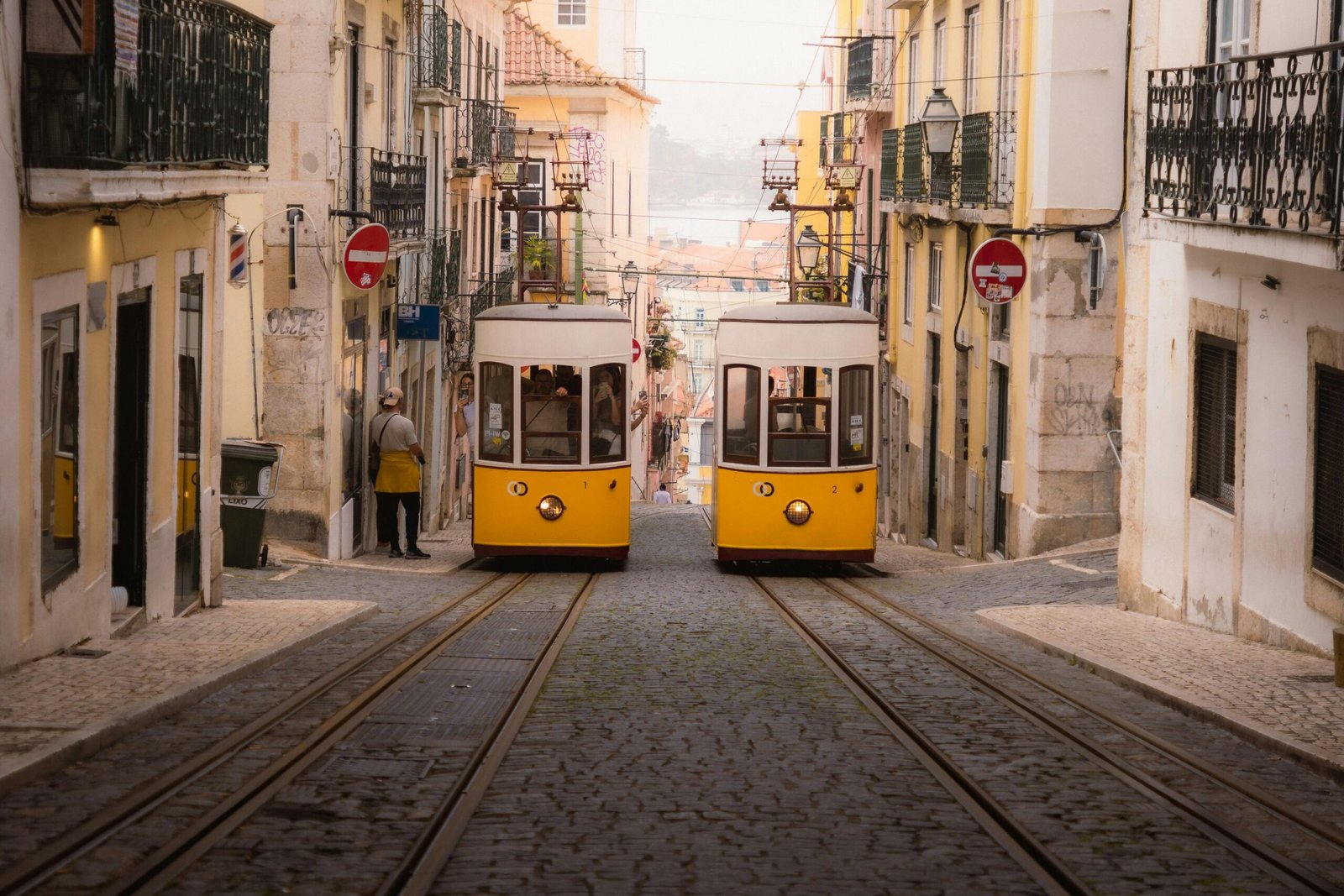 pexels-photo-29743111-29743111 Charming yellow trams navigate the historic cobblestone streets of Lisbon's old town.